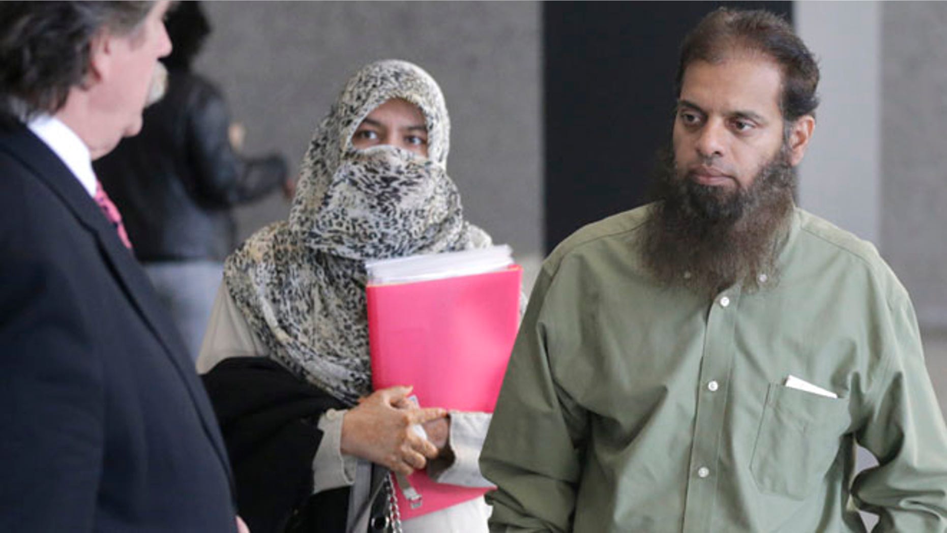 Oct. 9, 2014: Shafi Khan, right, and Zarine Khan, center, parents of Mohammed Hamzah Khan, meet with the family's attorney, Thomas Dirkin, left, before Khan's detention hearing in federal court in Chicago.