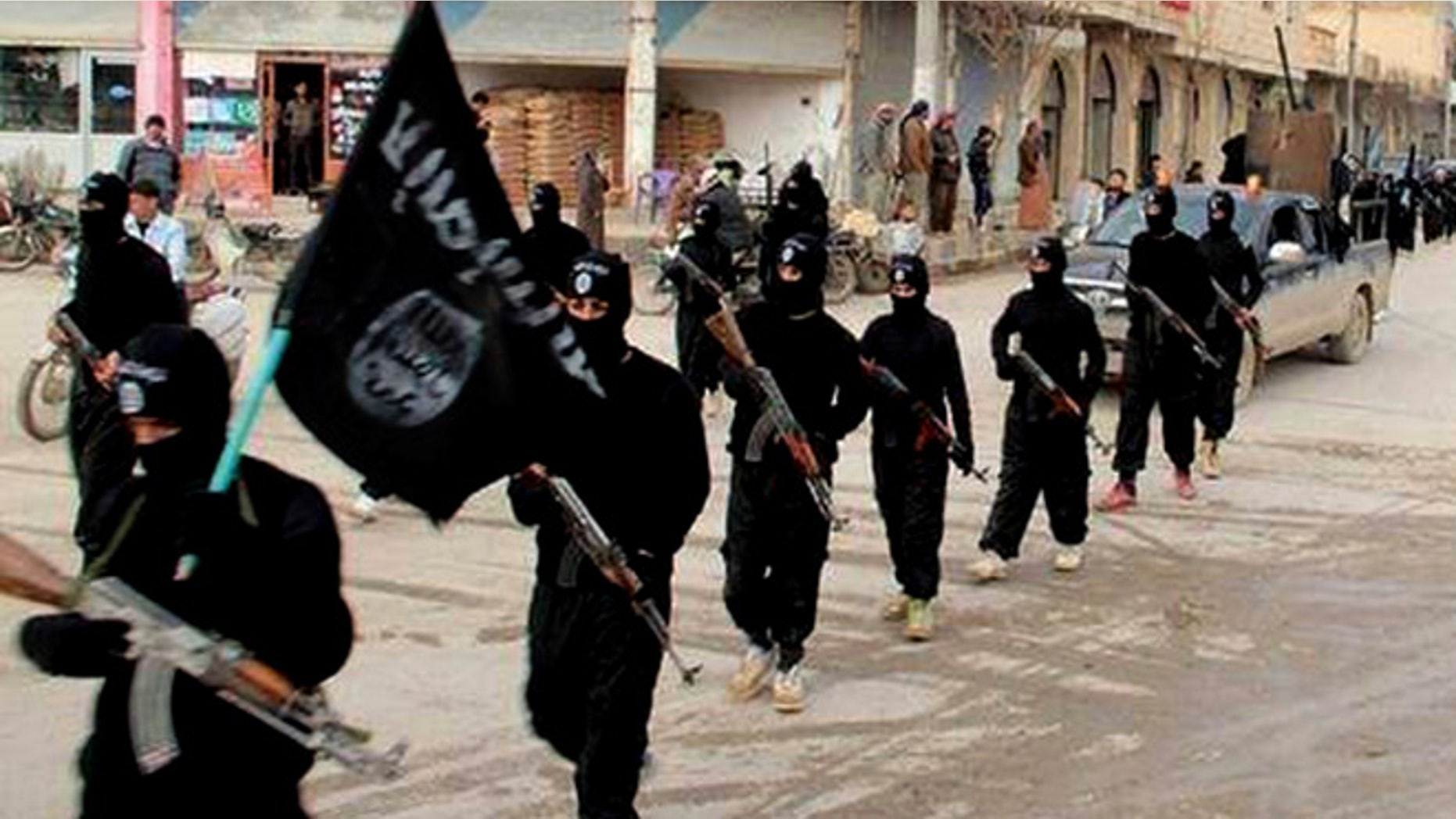 Jan. 14, 2014: This undated file image posted on a militant website on shows fighters from the al-Qaida-linked Islamic State of Iraq and the Levant (ISIS) marching in Raqqa, Syria.