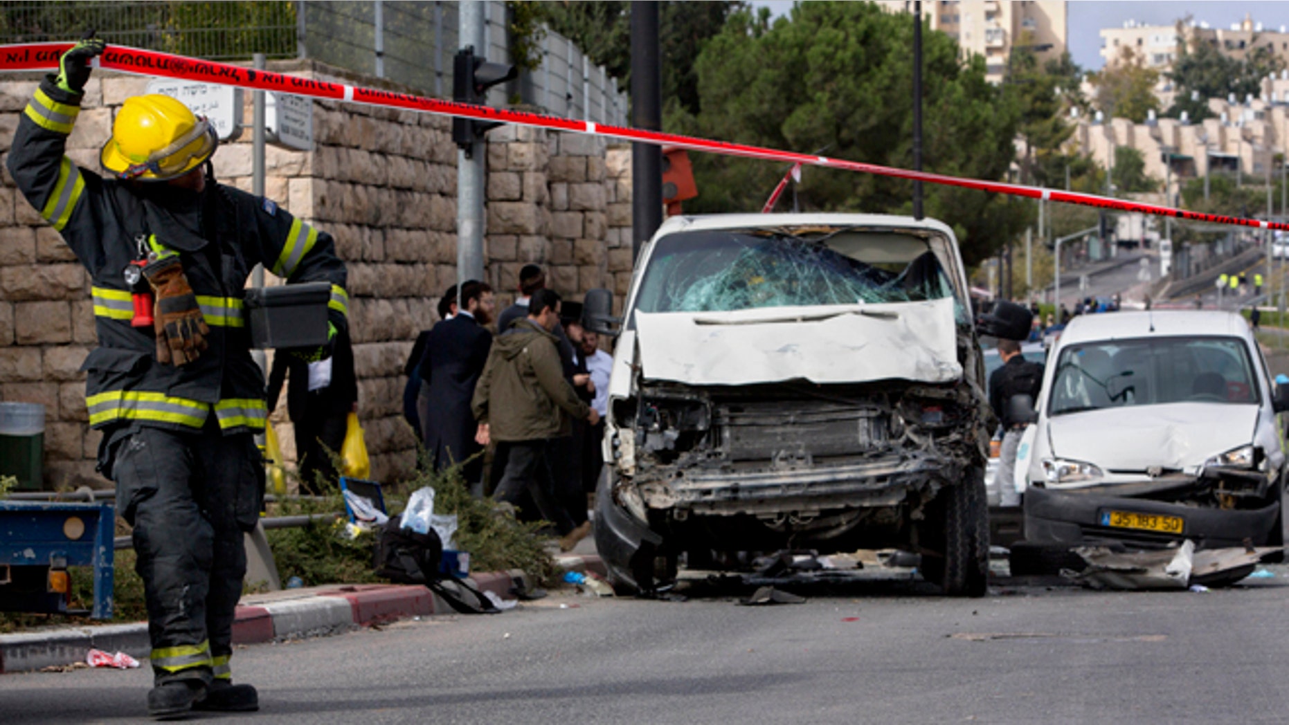 Nov. 5, 2014: An Israeli fire fighter walks at the scene of an attack in Jerusalem. A Palestinian man rammed his car into a crowded train platform in east Jerusalem on Wednesday and then attacked people with an iron bar, killing one person and injuring 13 in what authorities called a terror attack before he was shot dead by the police. The militant Islamic group Hamas took responsibility for the attack.