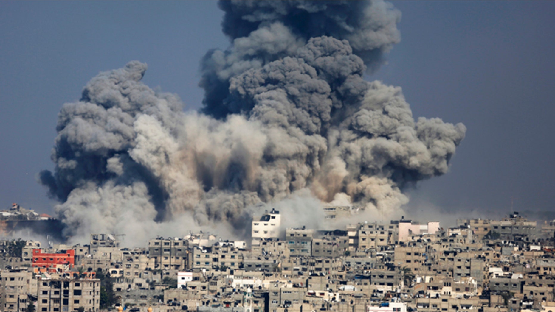 July 29, 2014: Smoke from the explosion of an Israeli strike rise over Gaza City. Israel escalated its military campaign against Hamas on Tuesday, striking symbols of the group's control in Gaza and firing tank shells that shut down the strip's only power plant in the heaviest bombardment in the fighting so far.