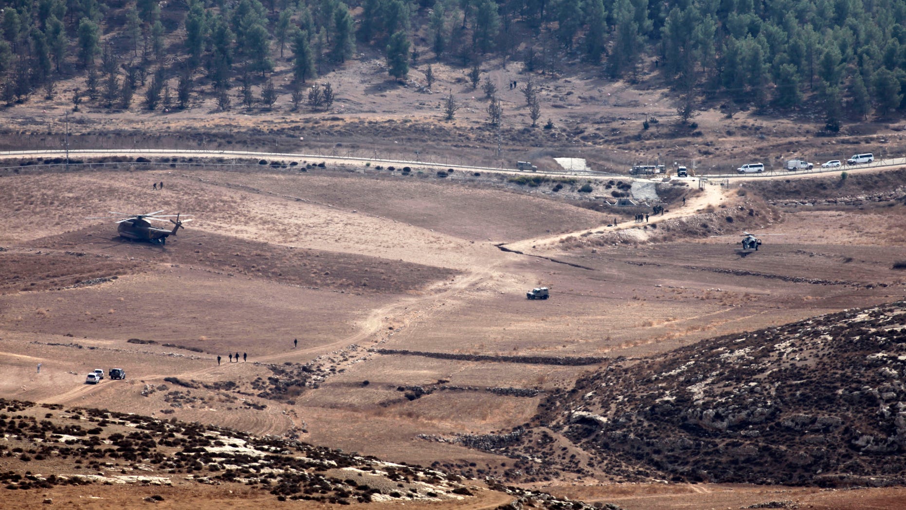 Oct. 6, 2012: Israeli Army vehicles and helicopters are seen in an open area as they search for the remains of a drone in the Negev southern Israel.