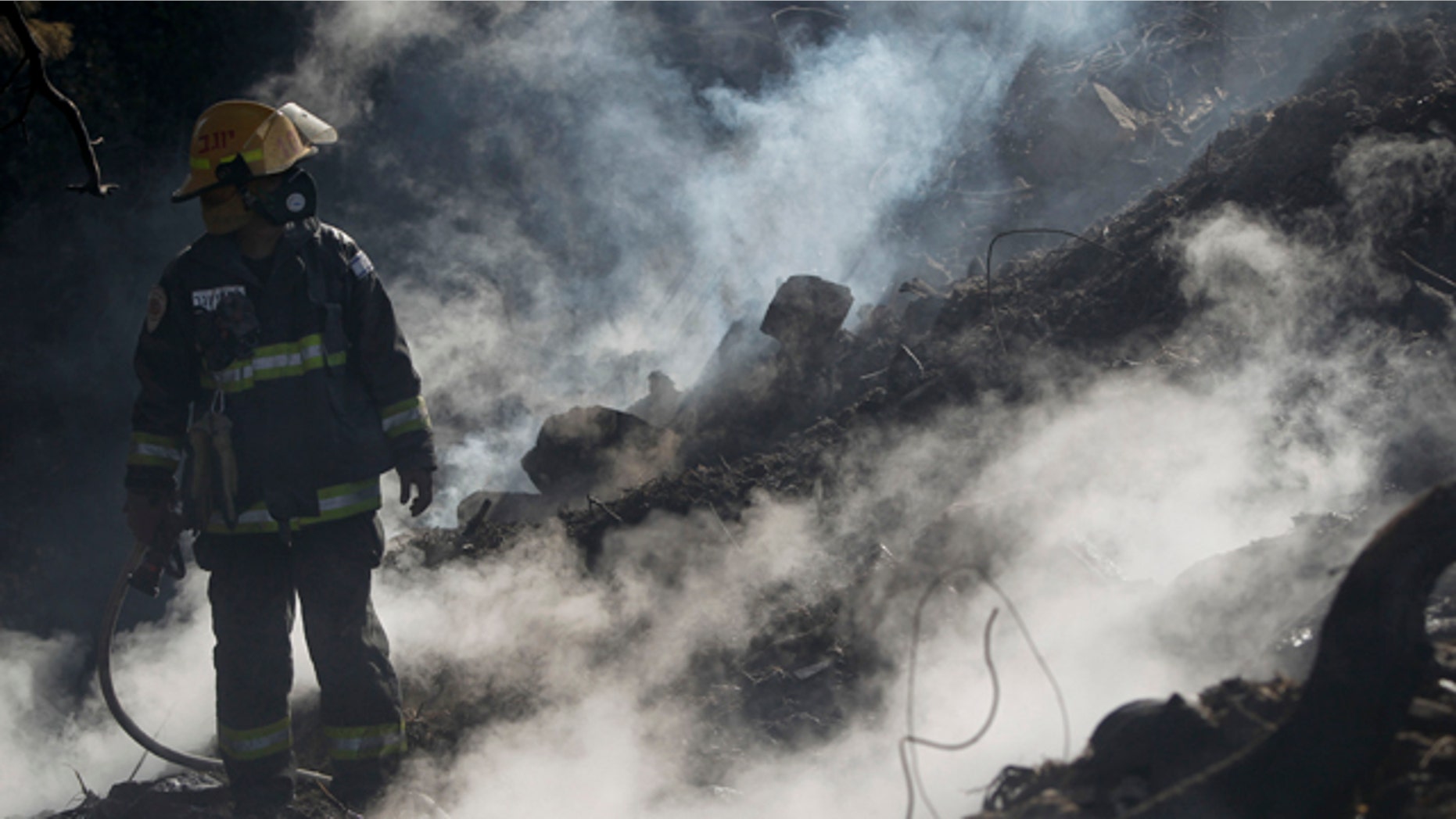 Dec. 5: An Israeli firefighter takes a break as he fights a blaze in the youth village (boarding school) of Yemin OrdE, near the northern city of Haifa, Israel. Israeli firefighters could bring a deadly wildfire sweeping through precious northern woodlands since last week under control Sunday, a fire service spokesman said. (AP)