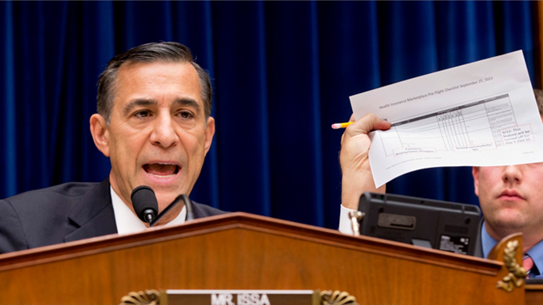 Nov. 13, 2013: House Oversight Committee Chairman Rep. Darrell Issa, R-Calif., holds up a checklist related to the preparation for the implementation of the ObamaCare healthcare program, and specifically, the HealthCare.gov website, on Capitol Hill in Washington.
