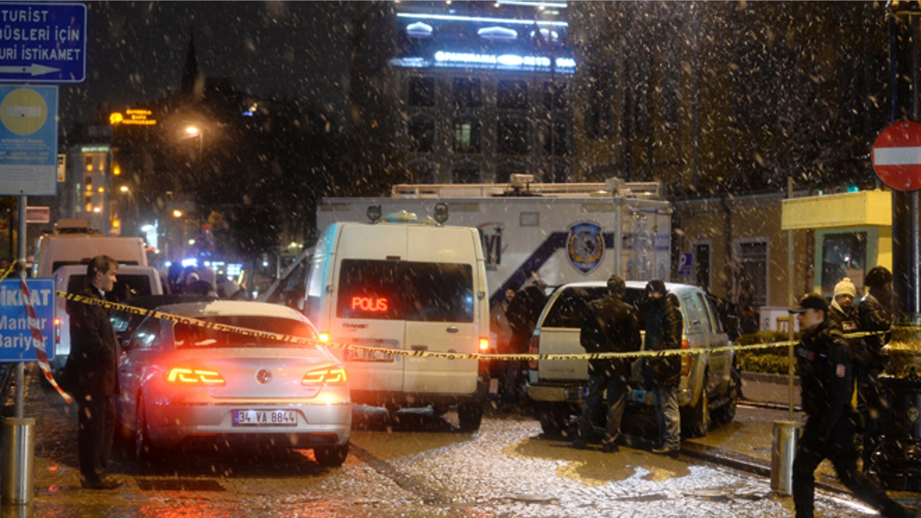 Jan. 6: Turkish security gather outside a police station where one police officer was killed and another injured after a suicide bomber blew herself up in Istanbul.