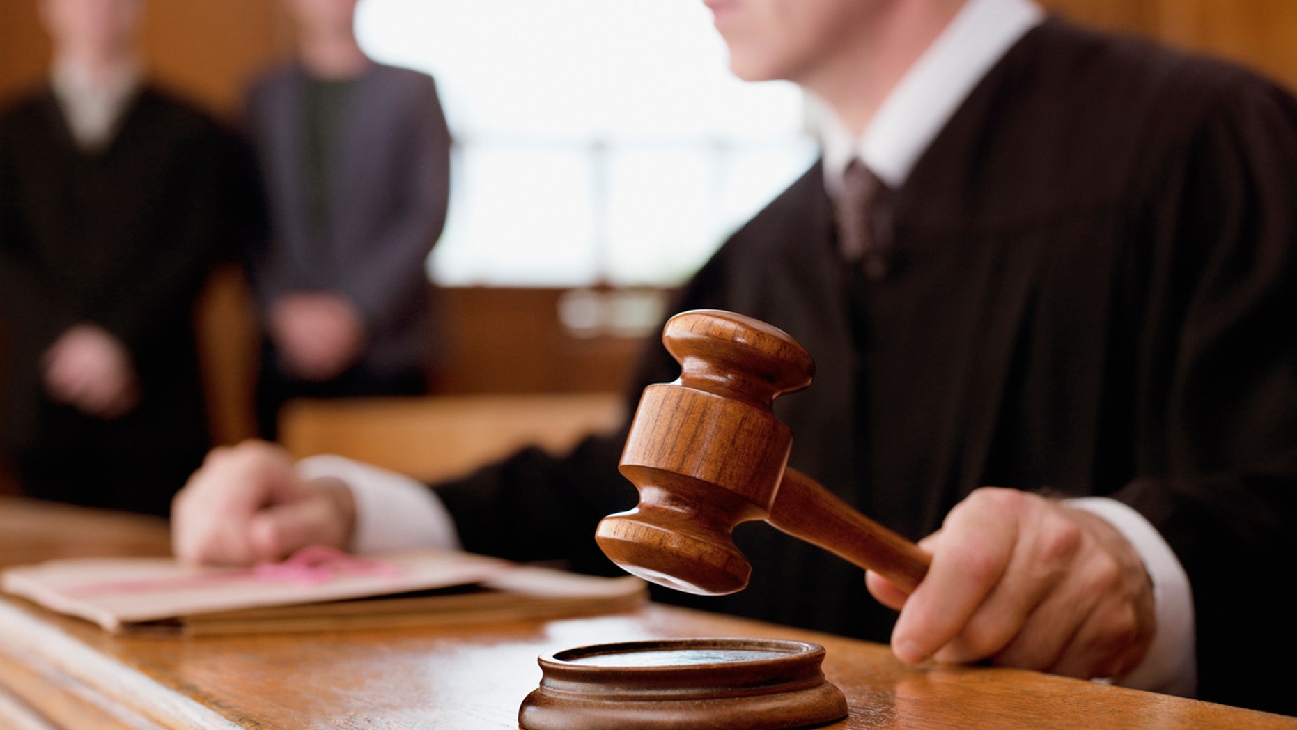 Judge holding gavel in courtroom