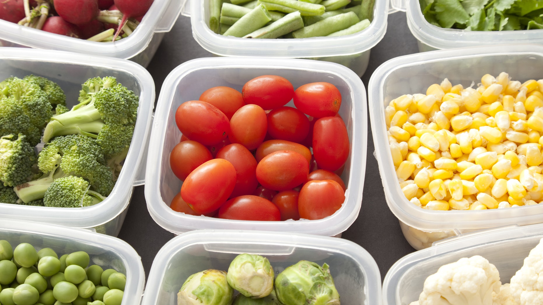 Different types of veggies each in a platic container