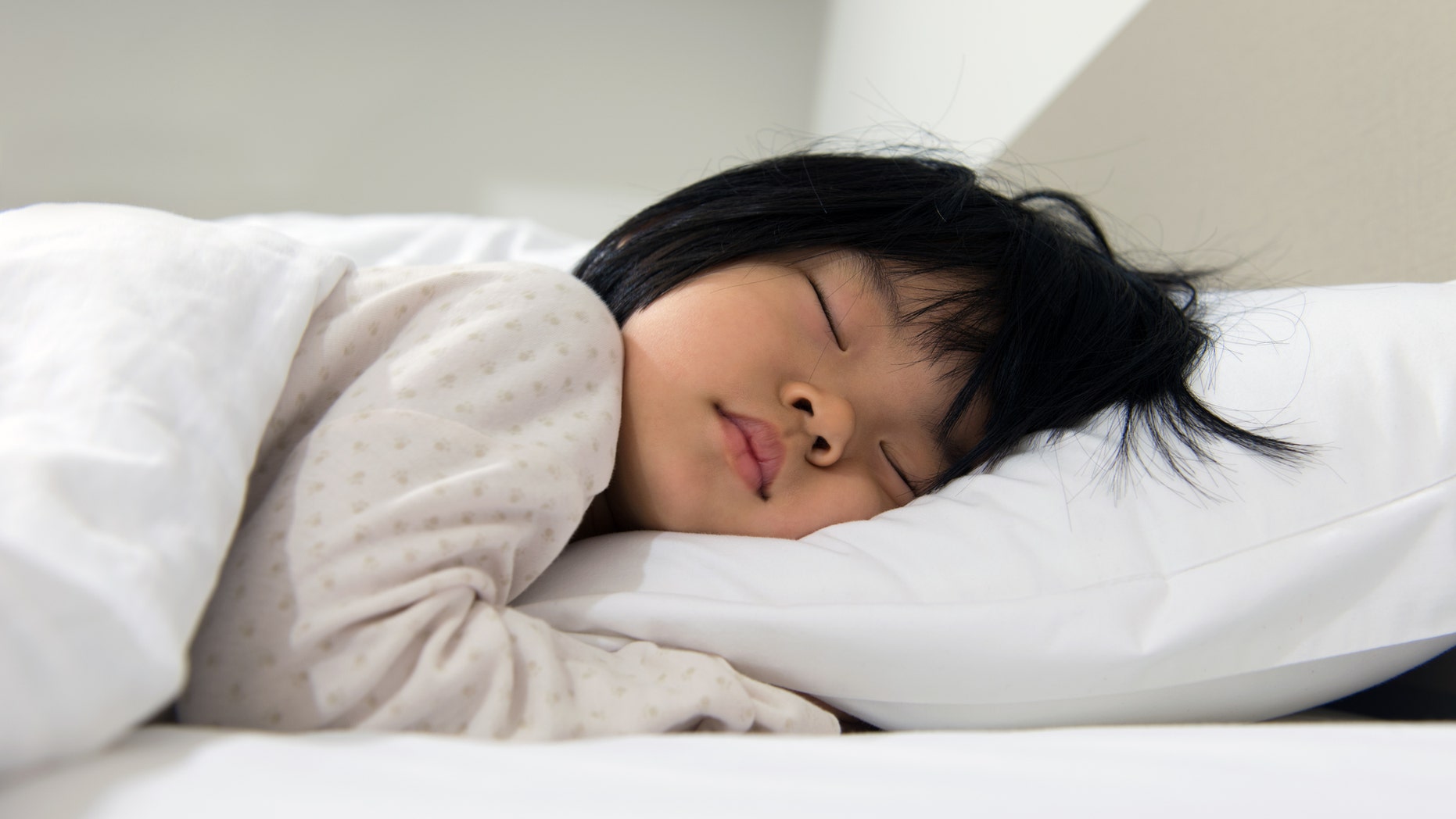 Portrait of Asian child sleeping on the bed