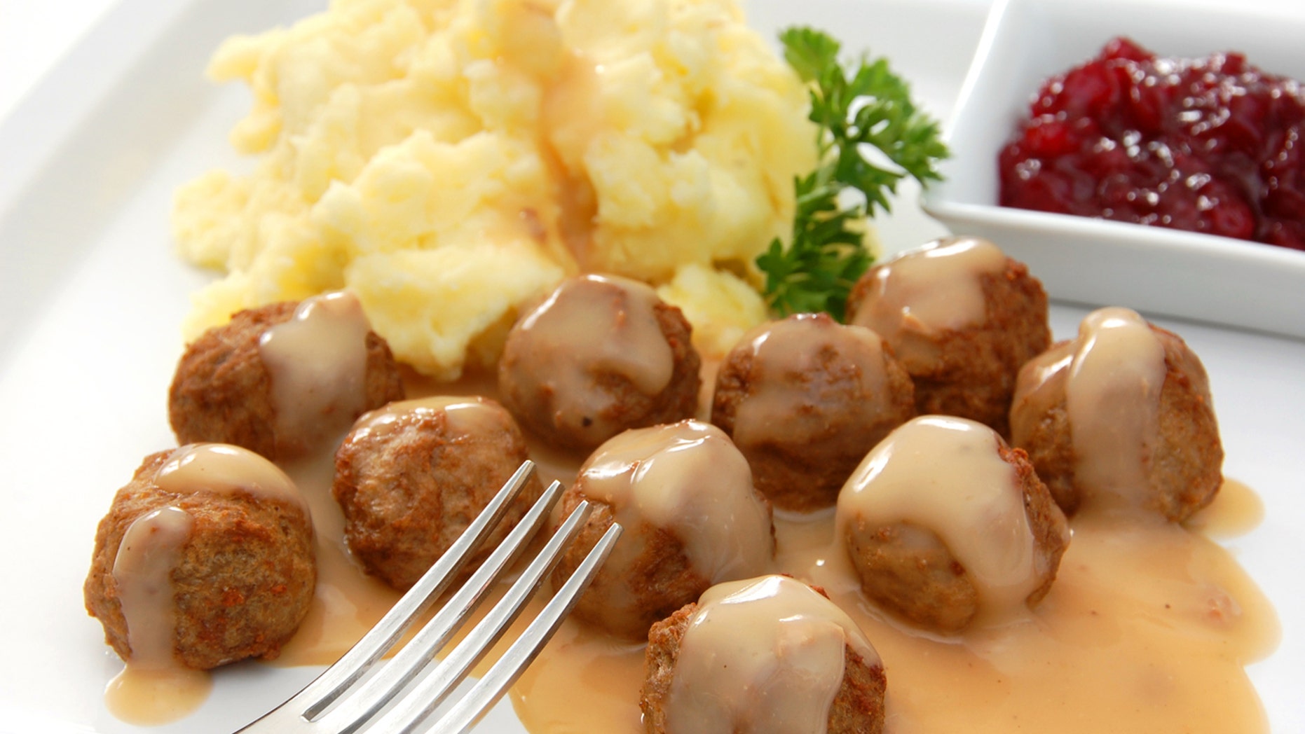 "Swedish meatballs served with the traditional accompaniments of gravy, mashed potatoes, and lingonberry sauce.More images from this series:"