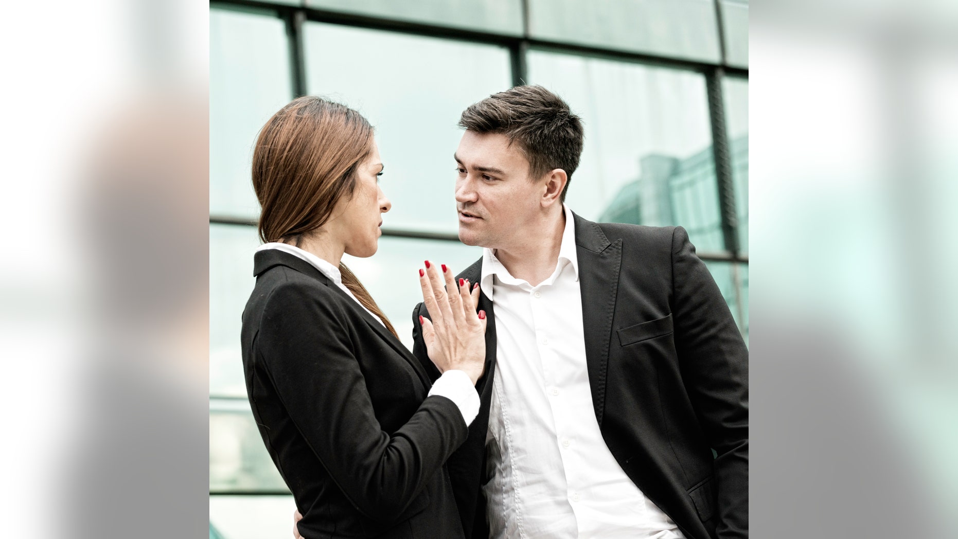 Sexual harassment at work - manager in aggressive stance towards younger female coleague