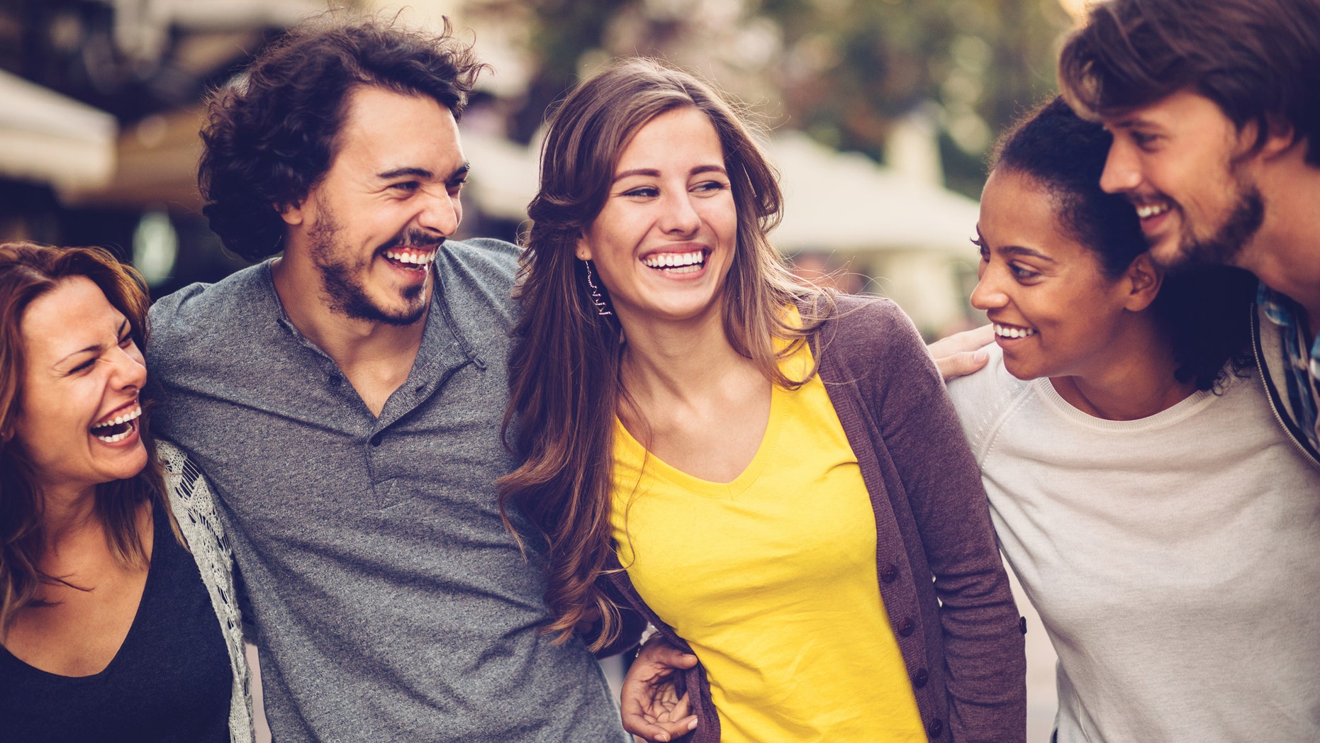 Group of mixed race people outdoors in the city, having a great time.