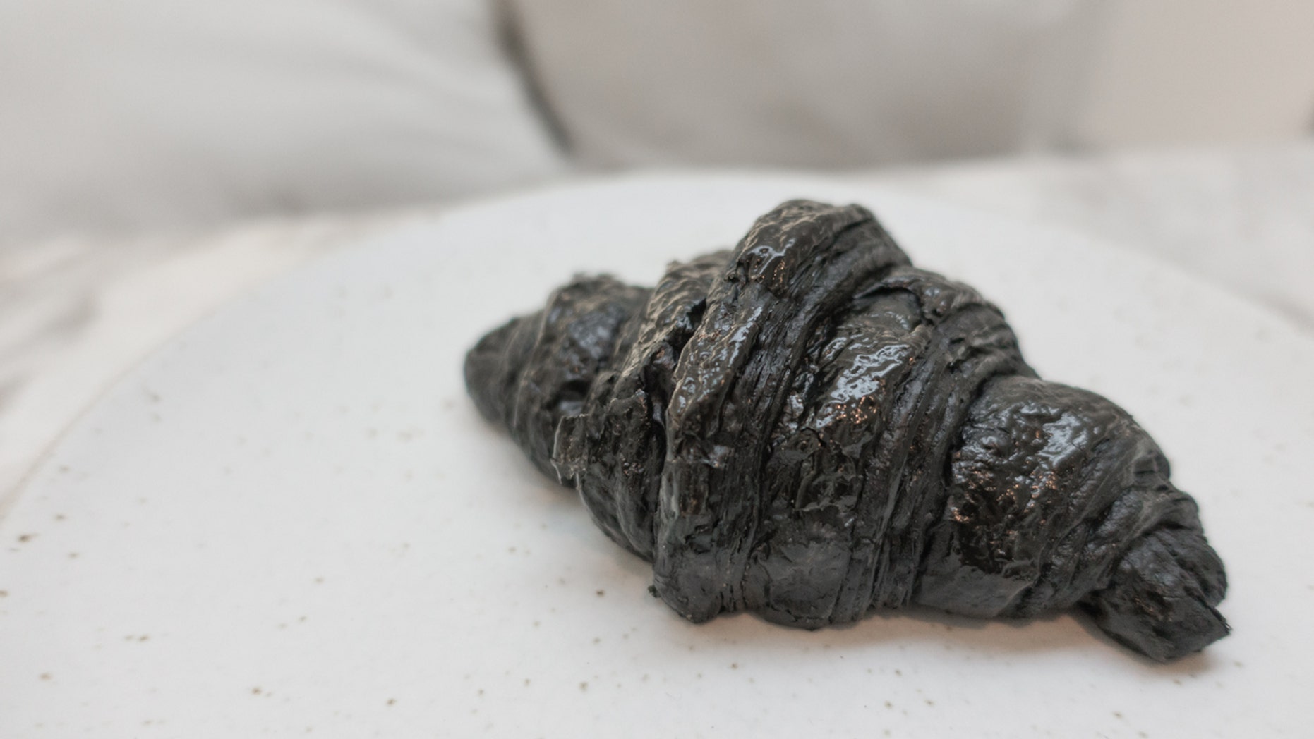 A cafe in London has debuted an activated charcoal vegan croissant that has some people losing their appetites.