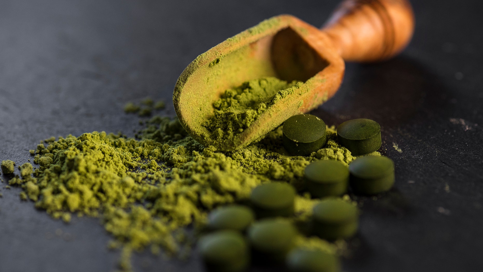 Organic chlorella powder and tablets shot on a slate