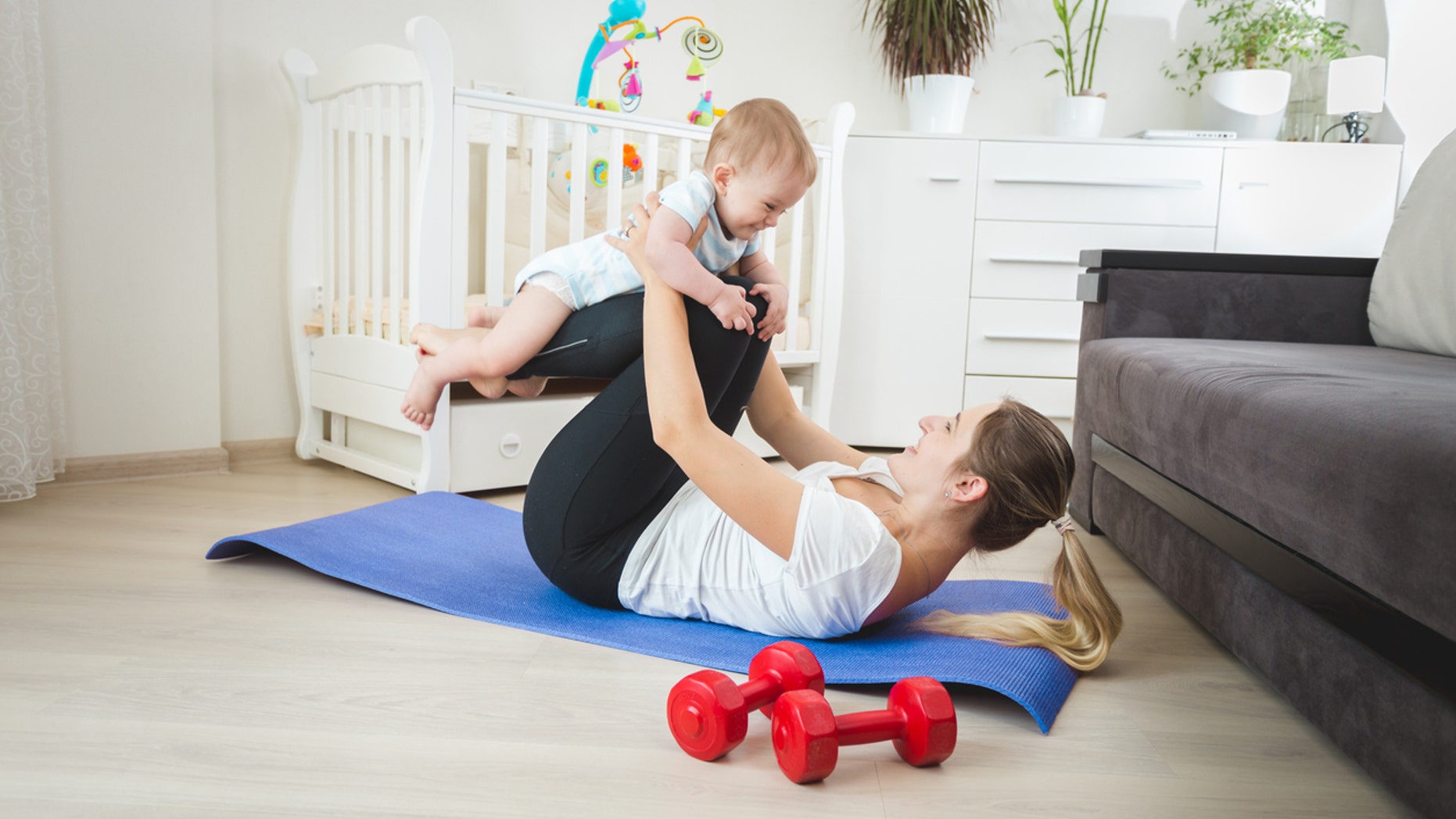 A mom's cool down session with her baby turned into a push-up contest, and the internet loves it.