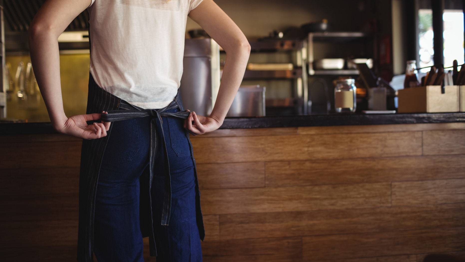 A religious woman is suing a restaurant for revoking her job offer.