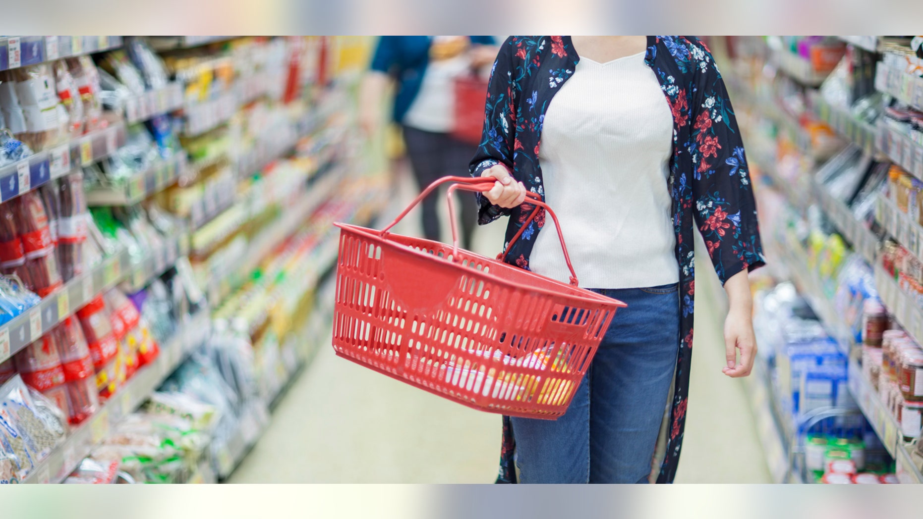 A young Japanese girl is shopping in a supermarket.