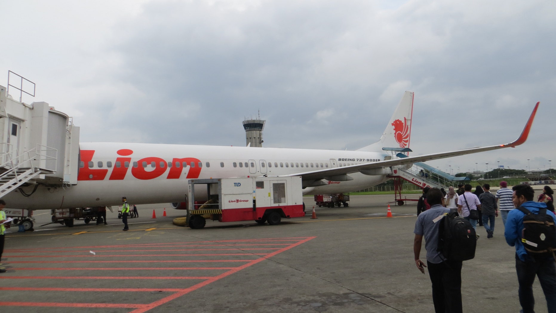 A man was taken into custody for repeatedly putting on a life jacket without being prompted by flight crew, and worrying other passengers.