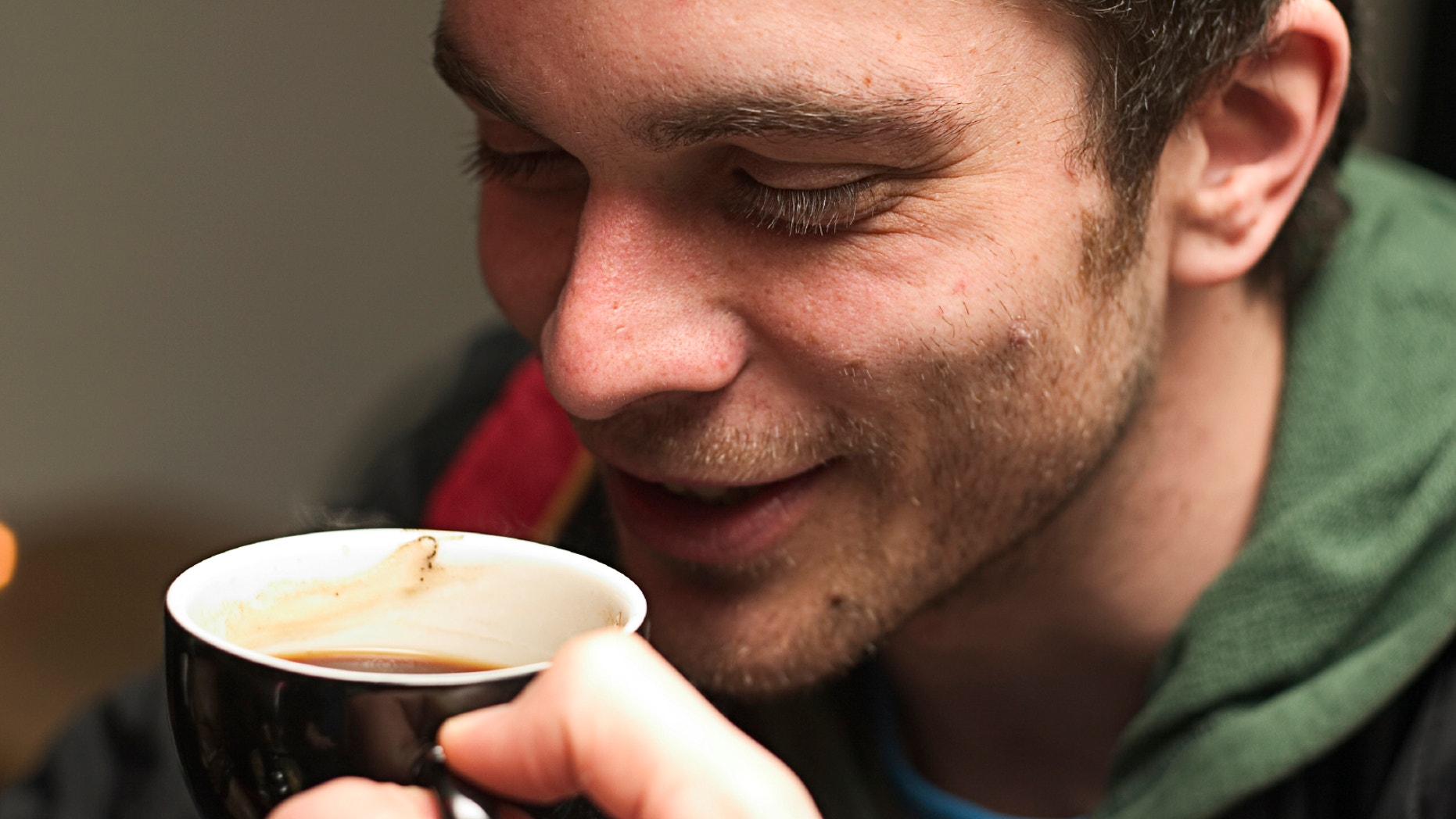 Young man enjoying a nice warm cup of coffee.