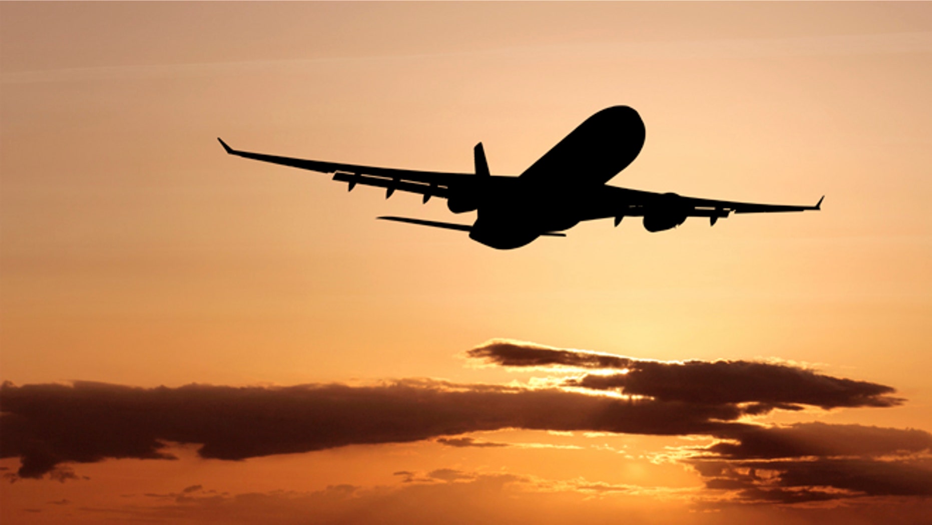 airliner silhouette taking off at dusk