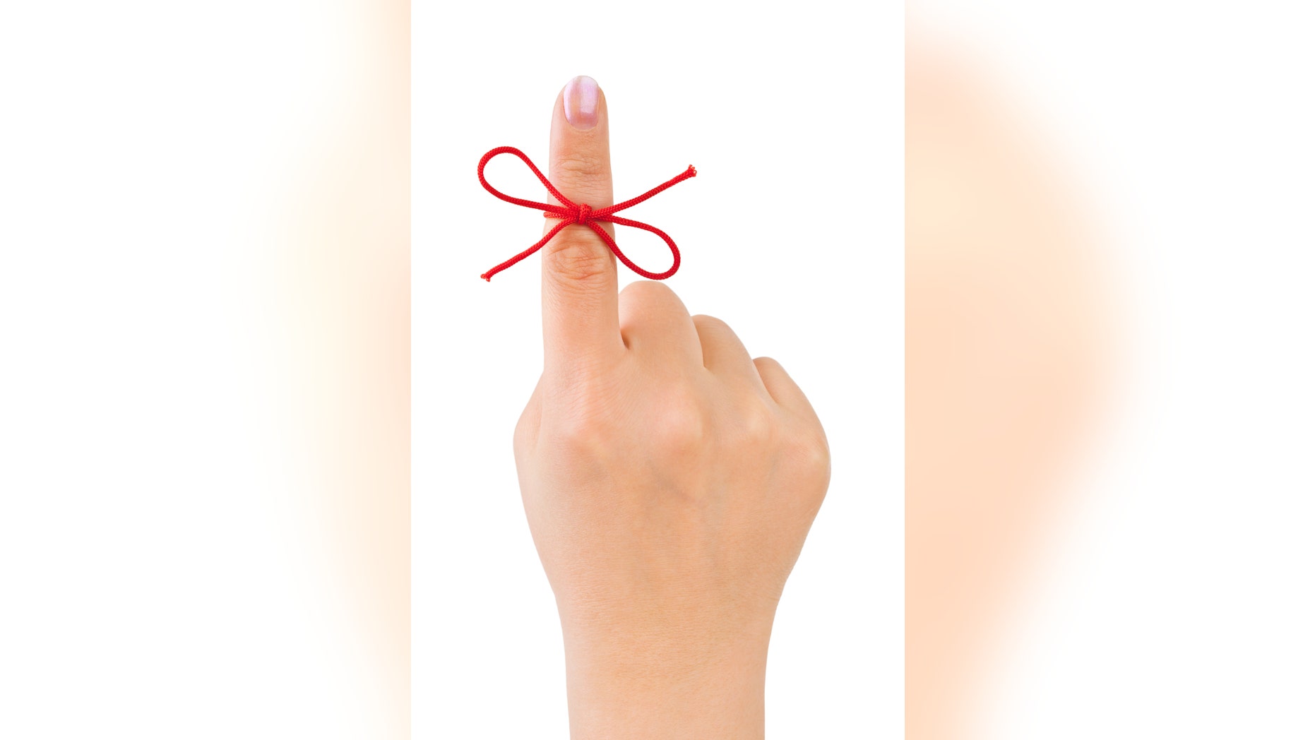 Red bow on finger isolated on white background
