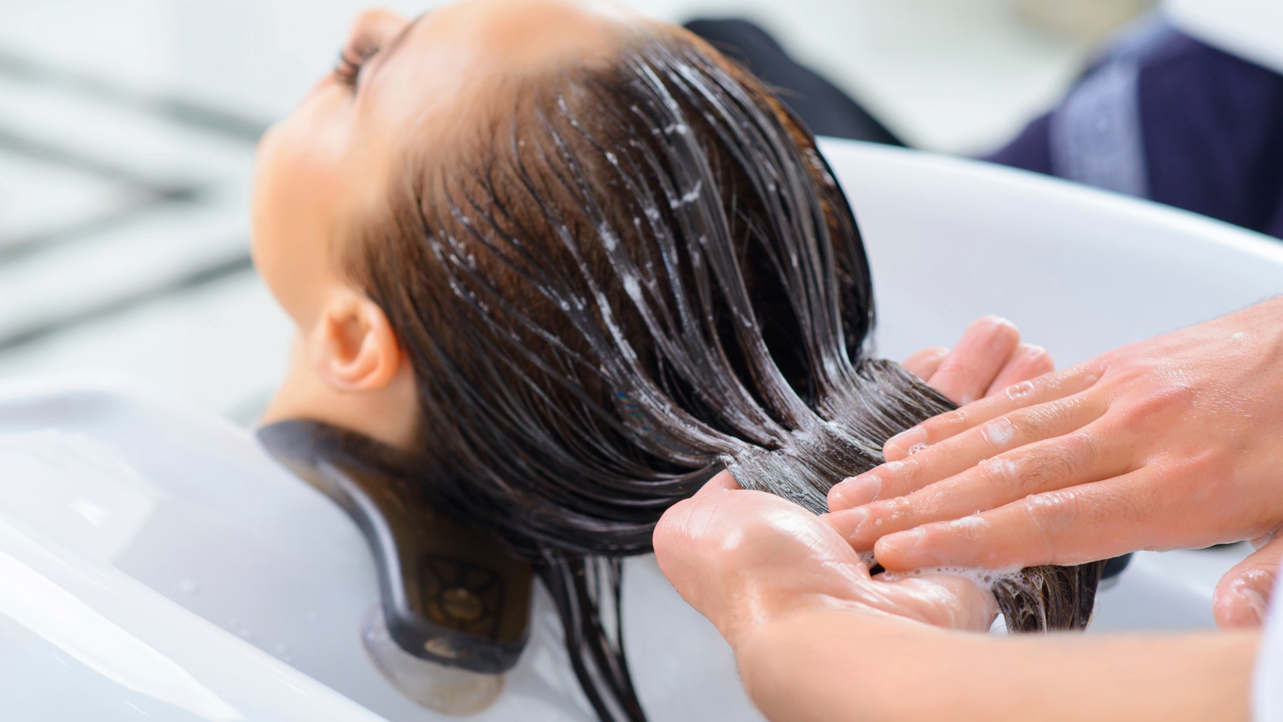 Professional treatment. Client is resting while her hair is being taken professional care.