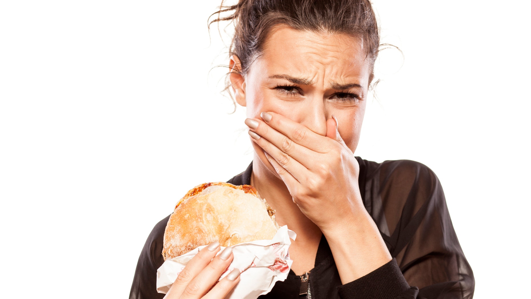 beautiful girl is disgusted by her sandwich