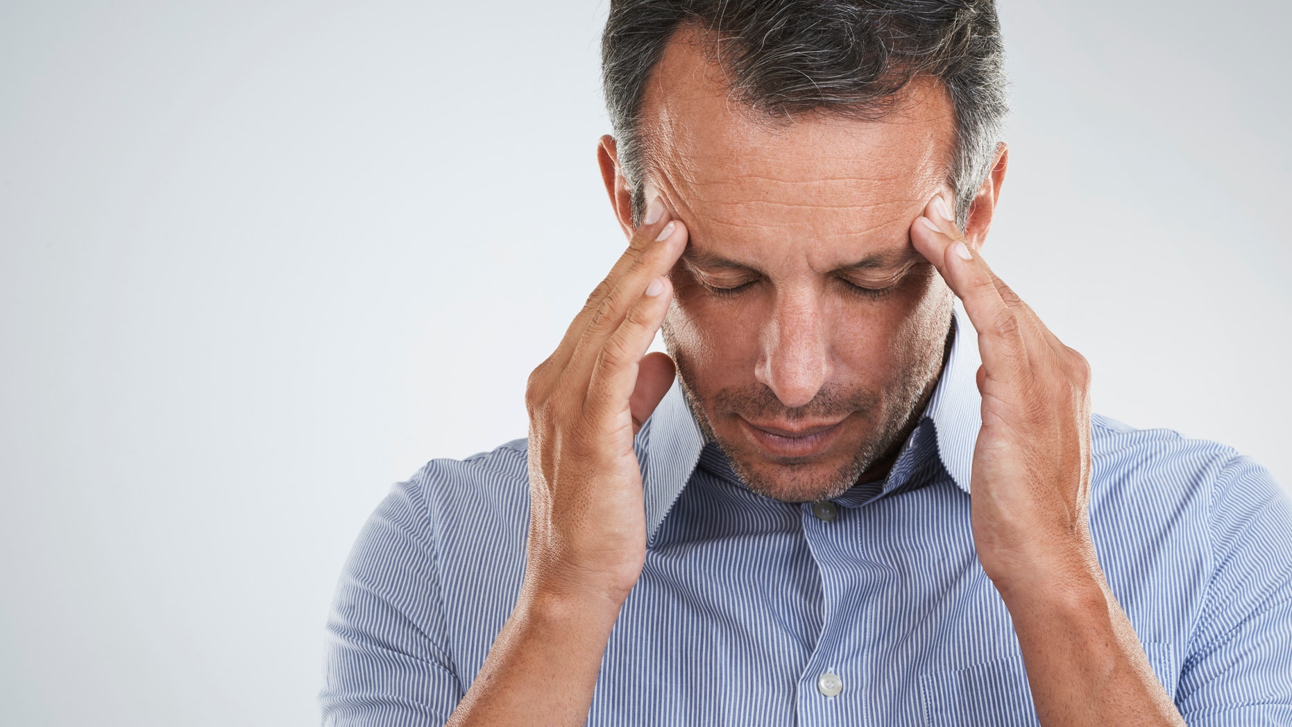 Studio shot of a mature man looking stressed out against a gray backgroundhttp://195.154.178.81/DATA/istock_collage/a3/shoots/785270.jpg