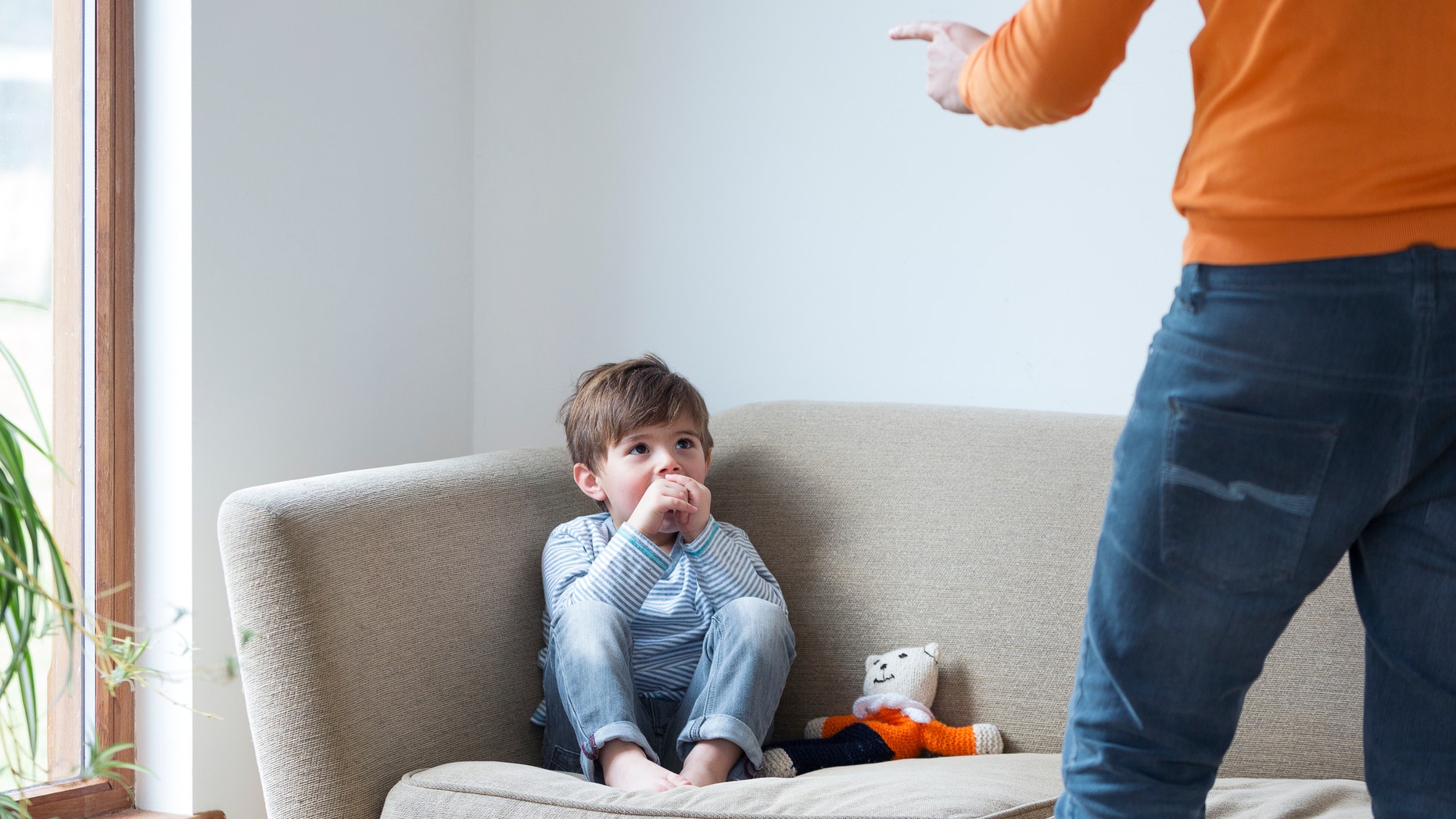 Little boy being shouted at by his dad.