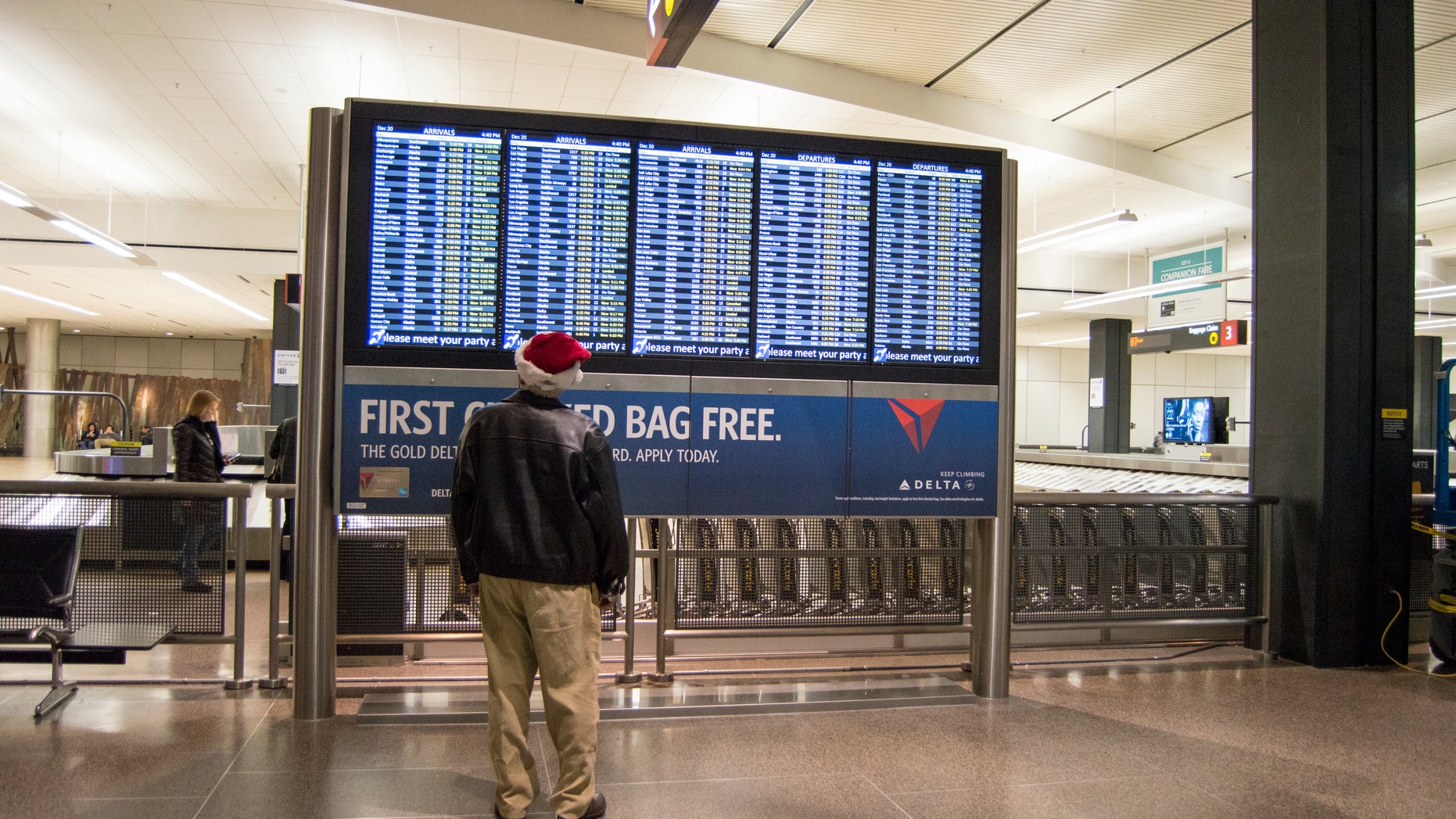 Seattle, WA, USA - December,20,2014 : A man standing in front of a billboard at the Seattle Airport