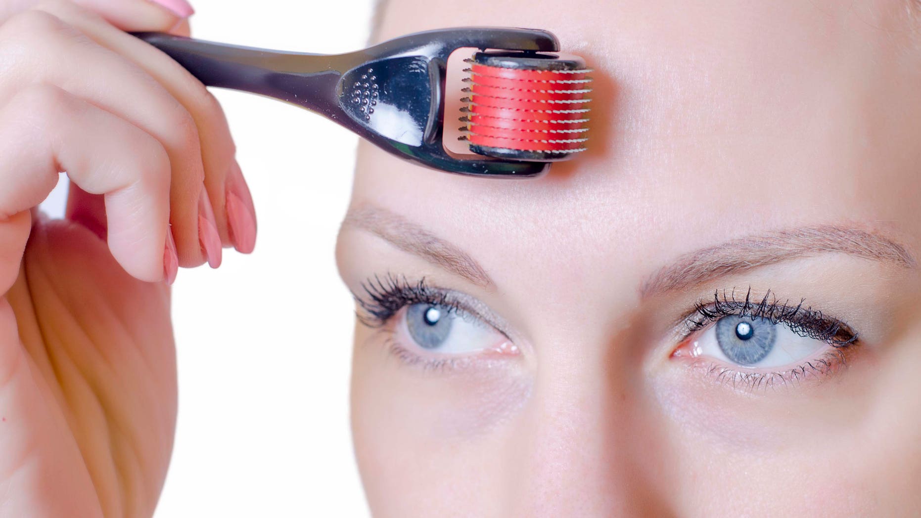 Medical cosmetic procedure. Mikronidling. Beautician performs Dermaroller procedure.