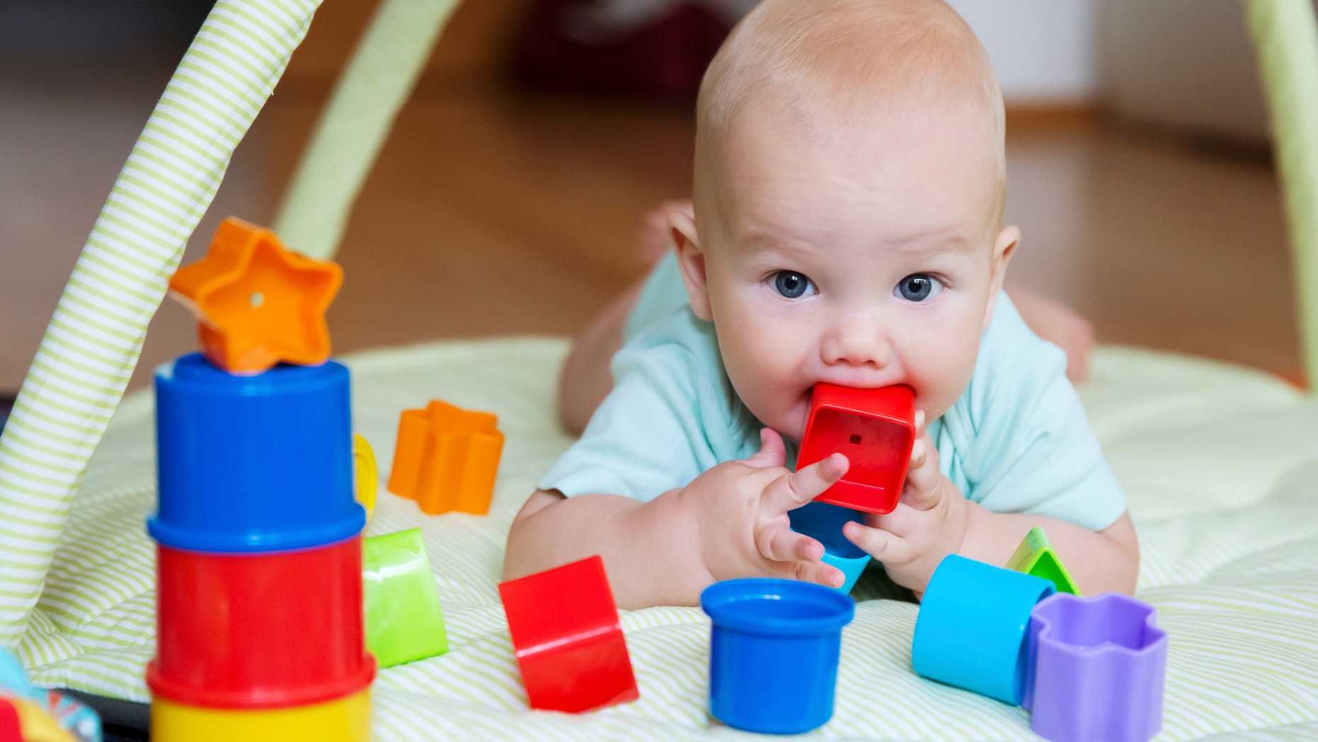Baby playing with colorful toys