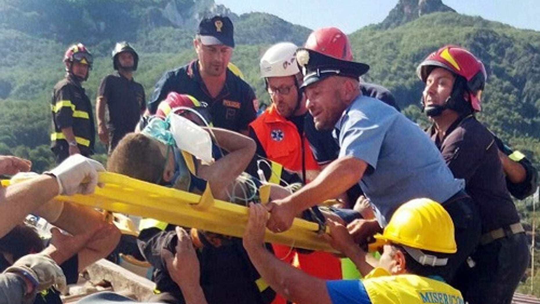Firefighters and rescue workers pull out a boy, Mattias, from the collapsed building in Casamicciola, near Naples, Italy, a day after a 4.0-magnitude quake hit the Italian resort island.