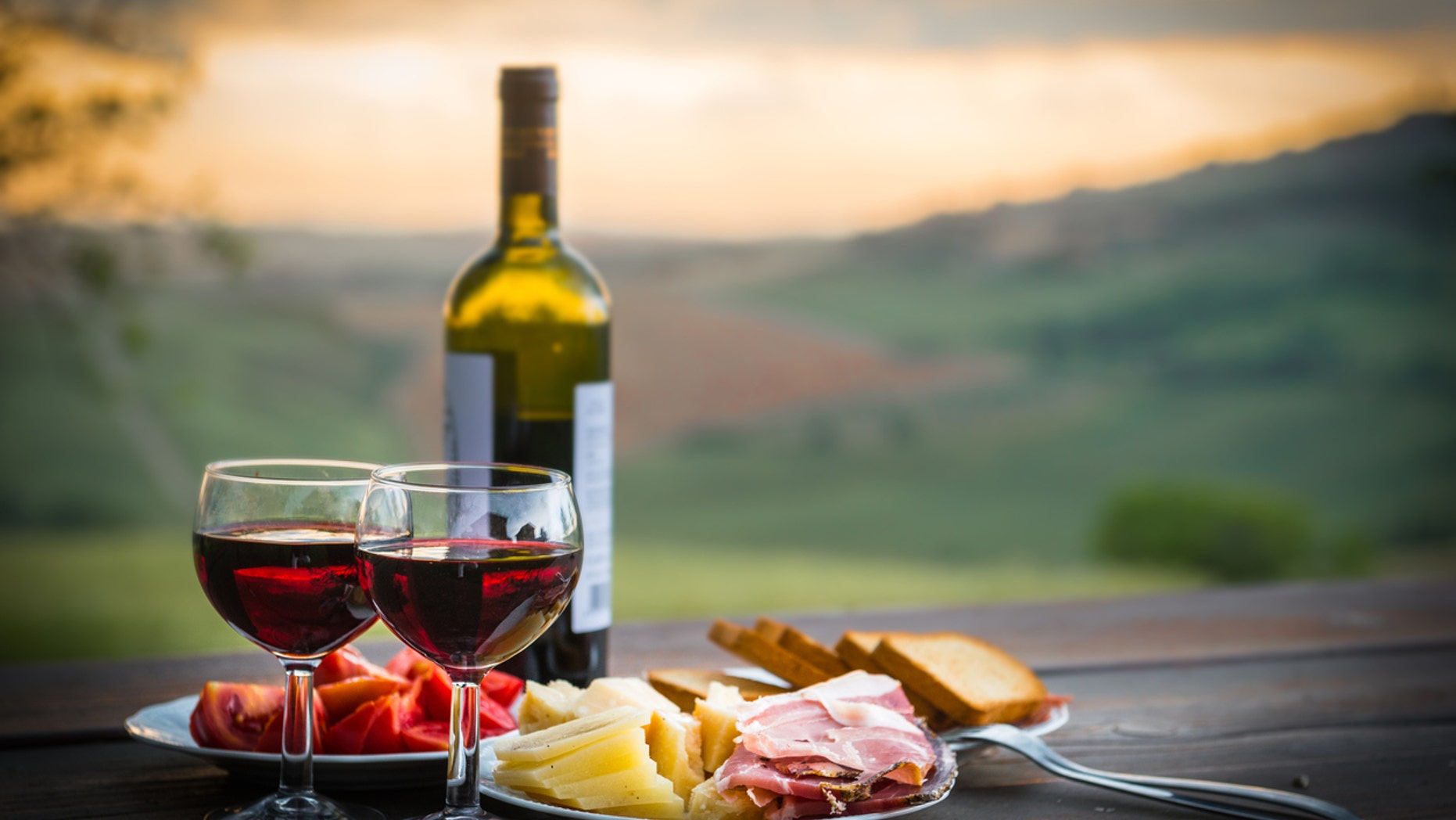 still life Red wine ,cheese and prosciutto. Romantic dinner outdoors