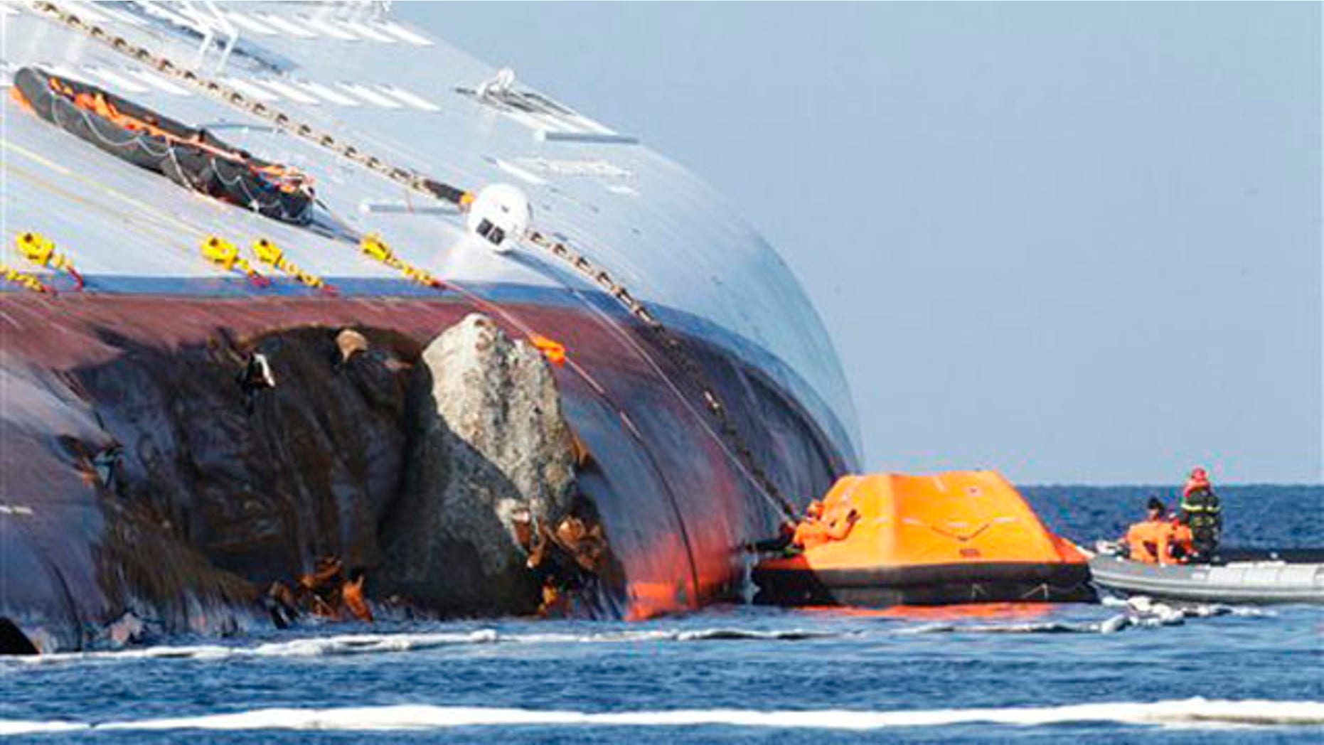 Jan. 24, 2012: Oil recovery experts work near the hole of the grounded cruise ship Costa Concordia off the Tuscan island of Giglio, Italy.