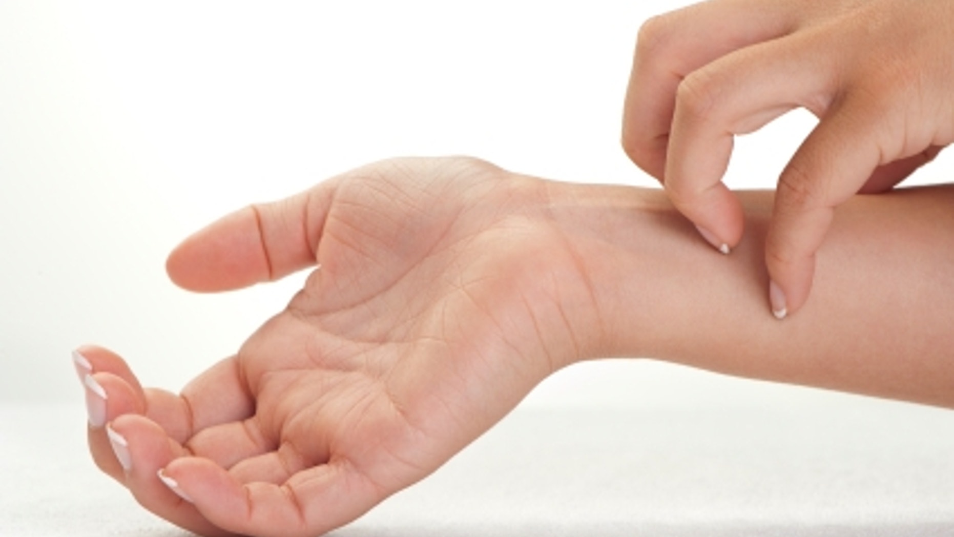 Close up of a woman scratching her skin