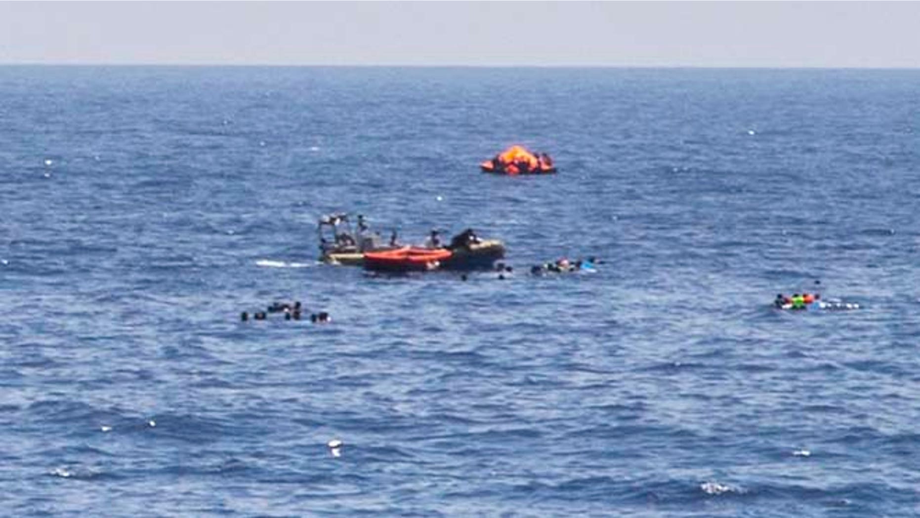 Aug. 5: The scene of the capsizing and sinking of a fishing boat crowded with migrants is seen from the deck of the Dignity I MSF search and rescue vessel which responded to the emergency in the Mediterranean sea off Libya.