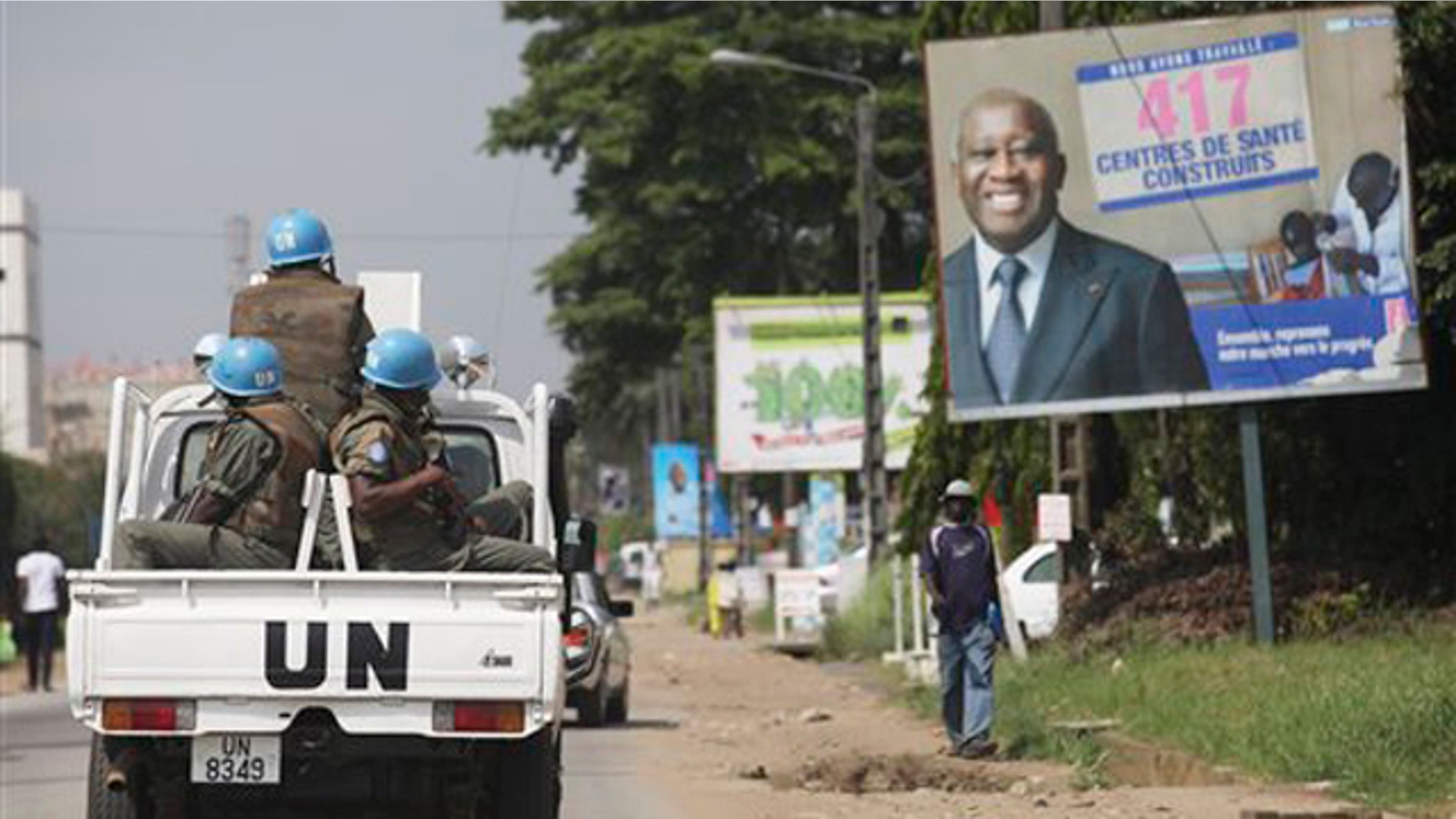 Dec. 23, 2010: U.N. forces drive past a billboard for President Laurent Gbagbo in Ivory Coast, Abidjan. The United Nations said Thursday that at least 173 people have been killed and dozens of others have gone missing or been tortured following Ivory Coast's disputed presidential election, which has prompted fears of a return to civil war.