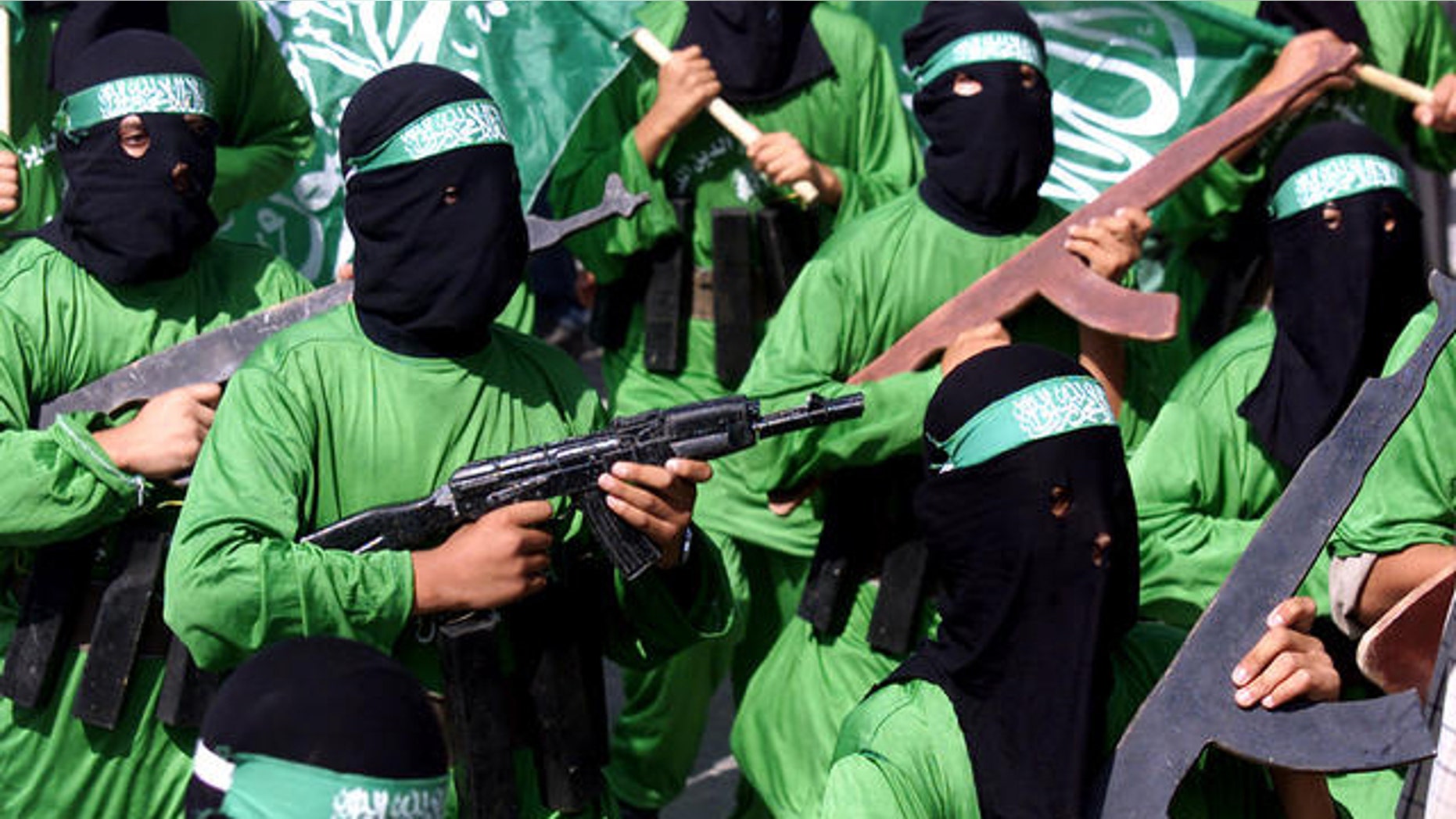 In this Oct. 24, 2003, file photo, Palestinian masked Hamas terrorists march during a protest rally at Jabaliya refugee camp in the Gaza Strip.