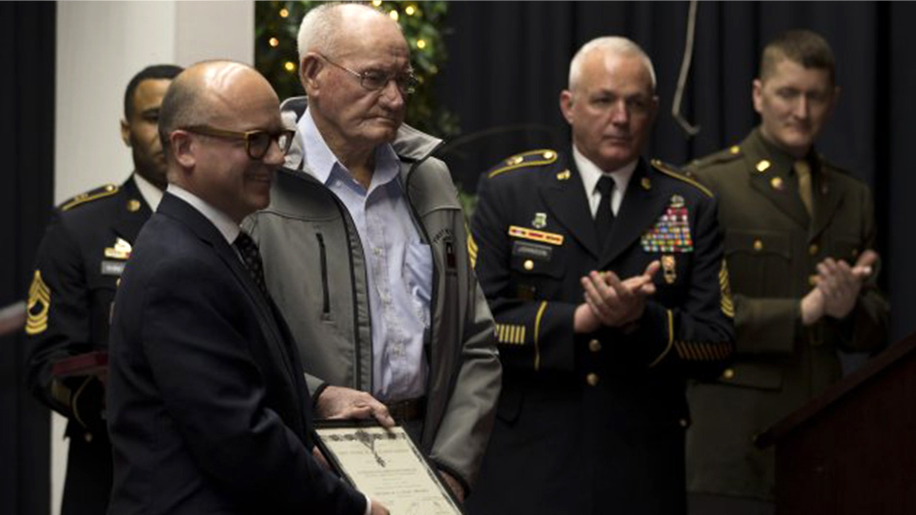 Guillaume Lacroix, l., consul general of France in Chicago, presented French Legion of Honor to 98-year-old Jack Baker, a former Army private first class who fought in World War II, at a ceremony in Olive Hill, Ky.