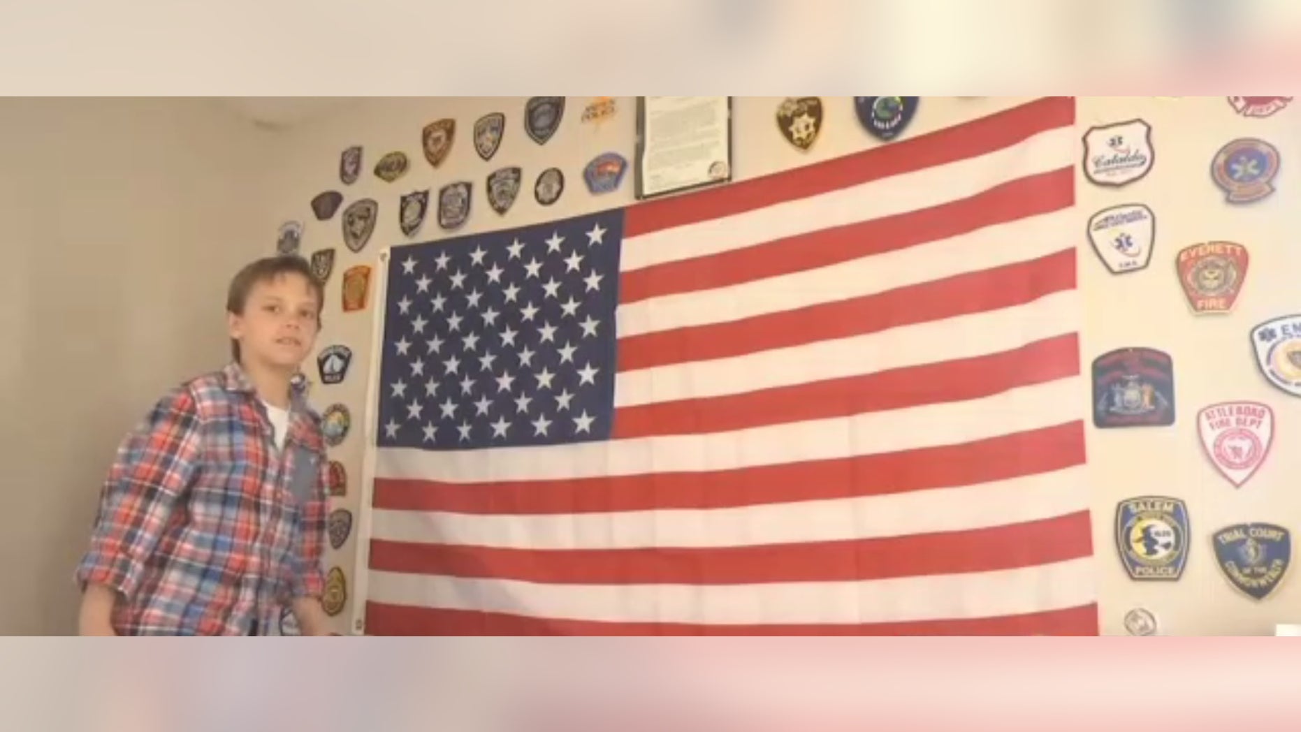 Jacob Rieger with badges sent to him from police departments across the country.