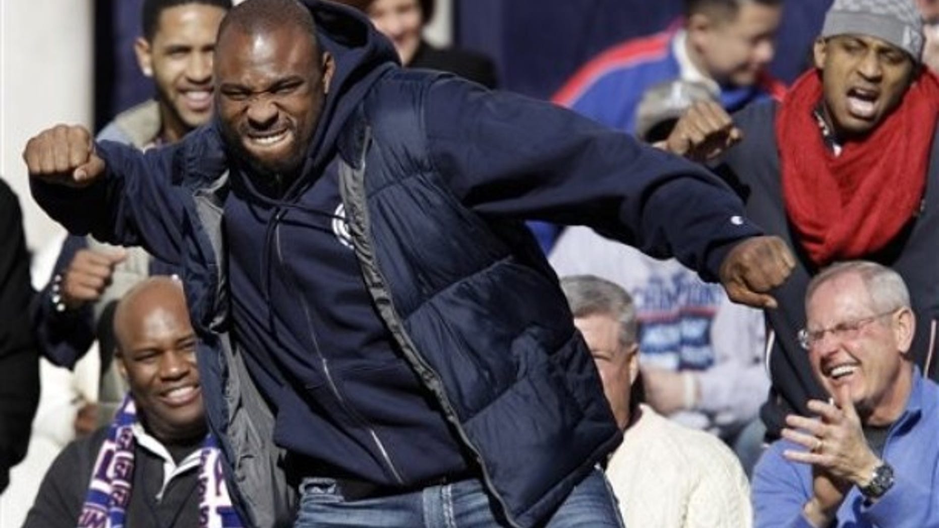 New York Giants head coach Tom Coughlin, lower right, applauds as running back Brandon Jacobs reacts on stage during a ceremony for the NFL football Super Bowl XLVI champions at City Hall in New York, Tuesday, Feb. 7, 2012. (AP Photo/Kathy Willens)