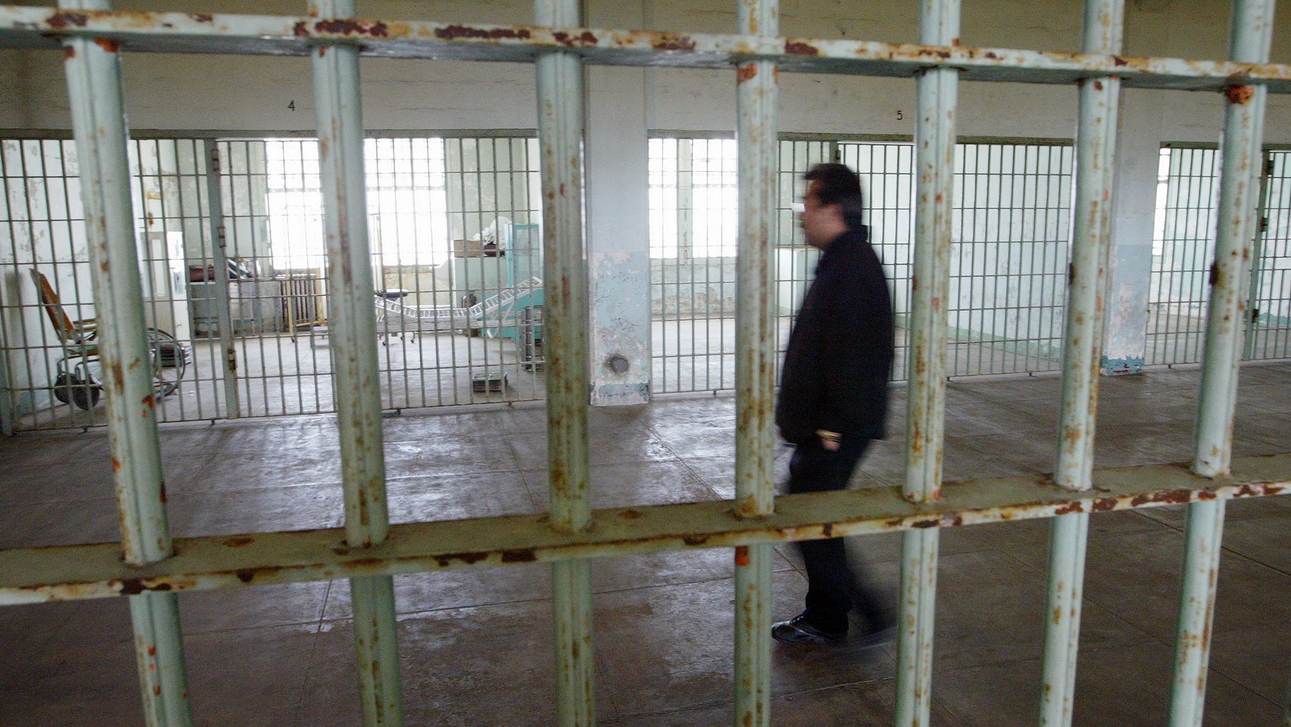 SAN FRANCISCO - JULY 2: Golden Gate National Recreation Area worker Edwin Sera walks through the hospital of the Alcatraz Federal Penitentiary on Alcatraz Island July 2, 2003 in the San Francisco Bay, California. The National Park Service, which manages Alcatraz as one of San Francisco's most popular tourist attractions, has started selling boxed chunks of concrete rubble for $4.95 which were left over from a 7.7 million dollar retrofit of a decaying cell block and guards quarters. Park staff came up with the idea as a cost-effective alternative to ferrying tons of rubble off Alcatraz and to bring in an extra $20,000 to $40,000 a year. (Photo by Justin Sullivan/Getty Images)