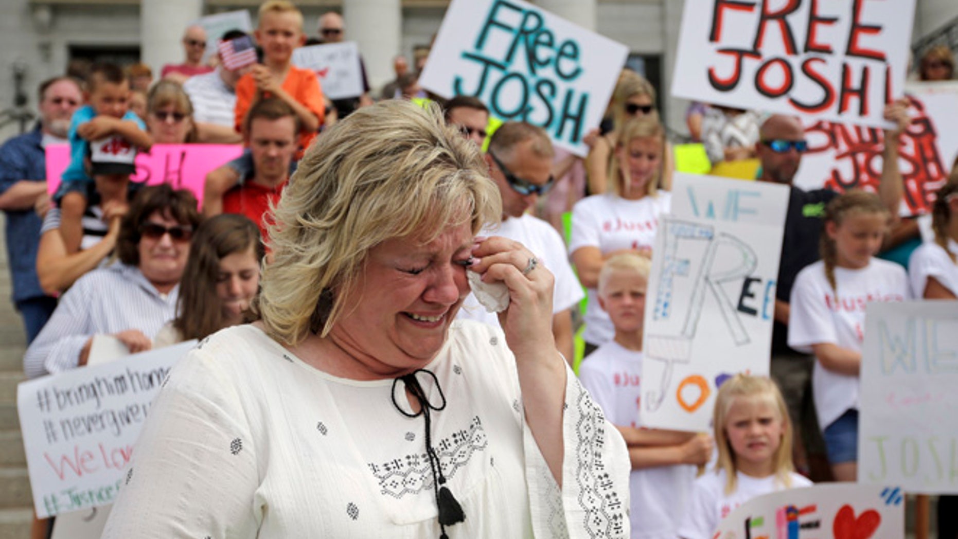 FILE - In this July 30, 2016, file photo, Laurie Holt, the mother of Joshua Holt, an American jailed in Venezuela, cries during a rally at the Utah State Capitol, in Salt Lake City.