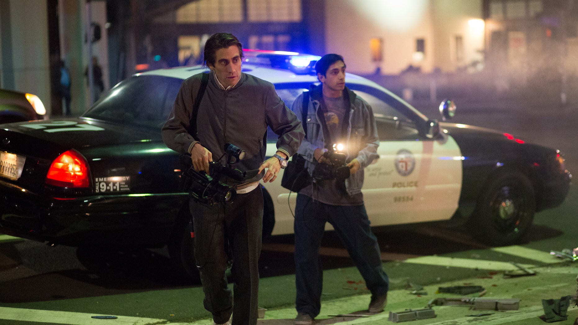 Jake Gyllenhaal, left, and Riz Ahmed appear in a scene from the film, "Nightcrawler."