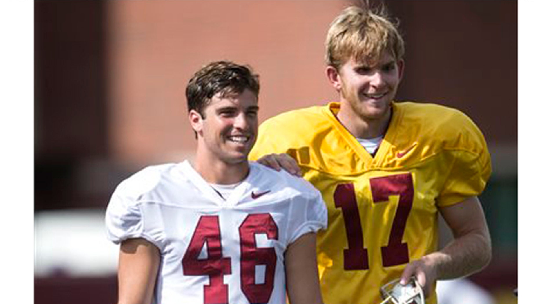 In this Sept. 15, 2015, file photo, Reid Budrovich, left, guides teammate Jake Olson, through the field during Southern California football practice in Los Angeles. (Ed Crisostomo/The Orange County Register via AP)