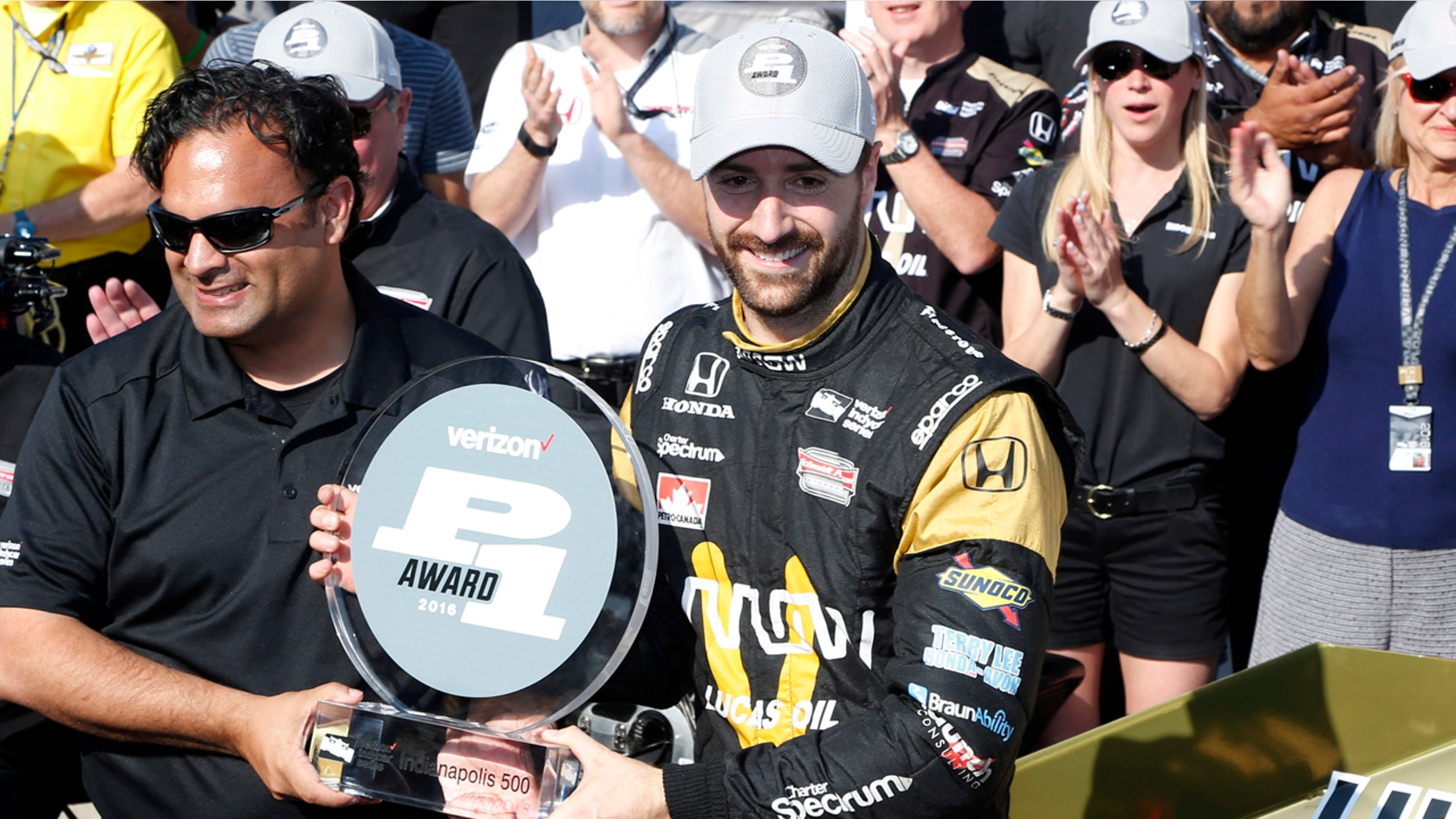 May 22, 2016; Indianapolis, IN, USA; Verizon Indy Car driver James Hinchcliffe accepts the pole award after winning the pole as the fastest qualifier during qualifications for the Indianapolis 500 at Indianapolis Motor Speedway. Mandatory Credit: Brian Spurlock-USA TODAY Sports - RTSFFWX
