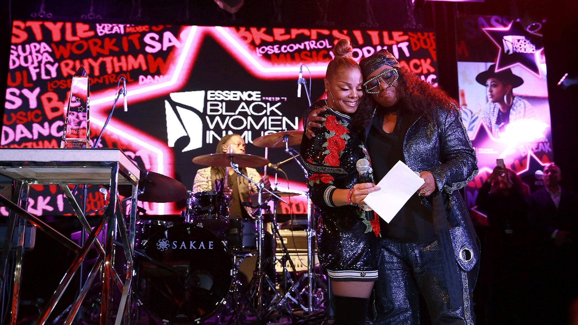 Janet Jackson, left, and Missy Elliott share a moment onstage at the ninth annual Essence Black Women in Music event at the Highline Ballroom in New York City, Jan. 25, 2018.