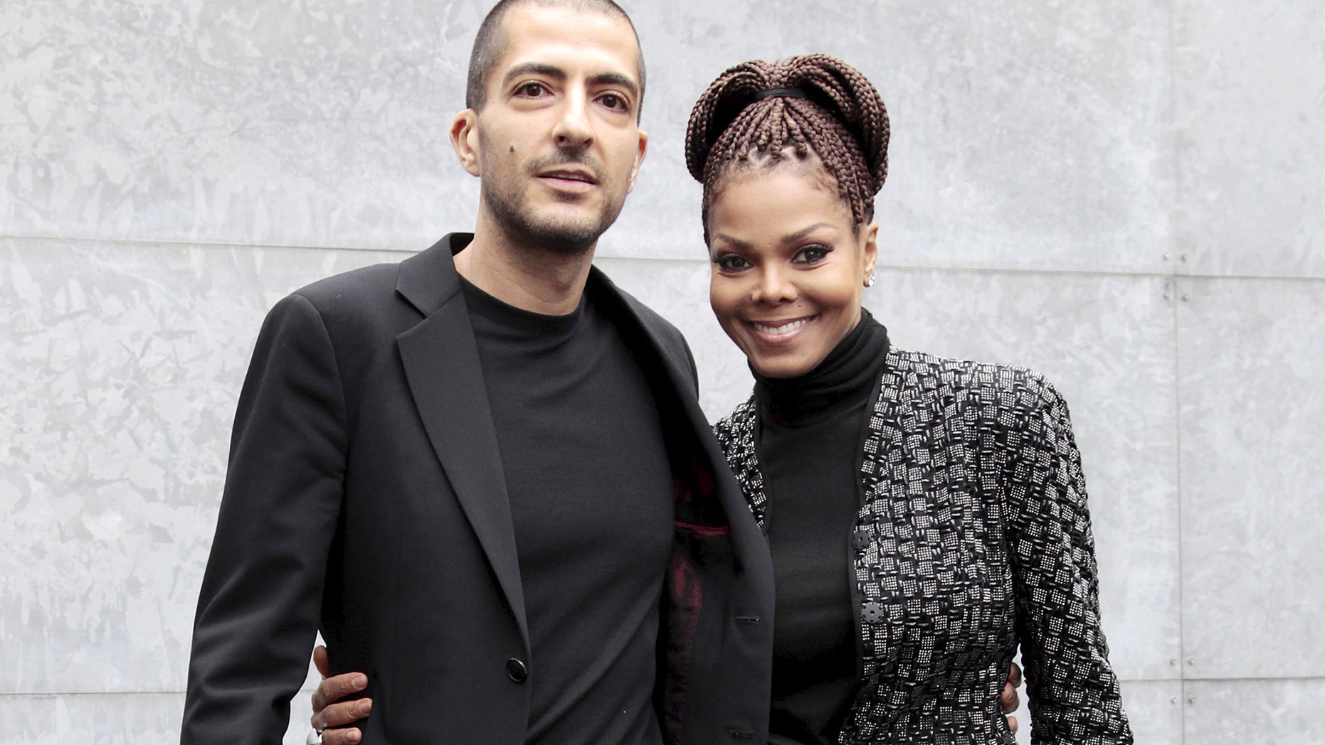 U.S. singer Janet Jackson (R) and her then boyfriend Wissam Al Mana pose for photographers as they arrive to attend the Giorgio Armani Autumn/Winter 2013 collection at Milan Fashion Week, February 25, 2013. REUTERS/Alessandro Garofalo/File Photo - RTSRYVN