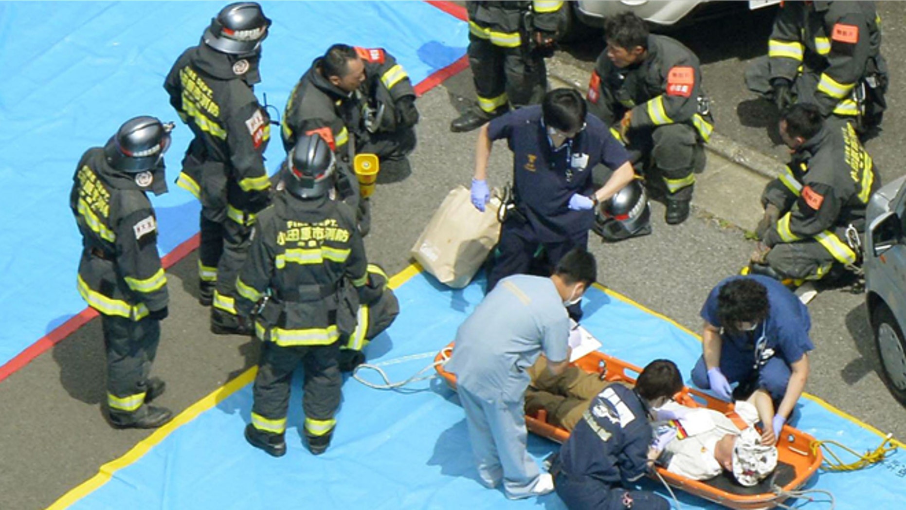 June 30, 2015: Passengers of a Shinkansen bullet train which made an emergency stop, receive treatment in Odawara, west of Tokyo.