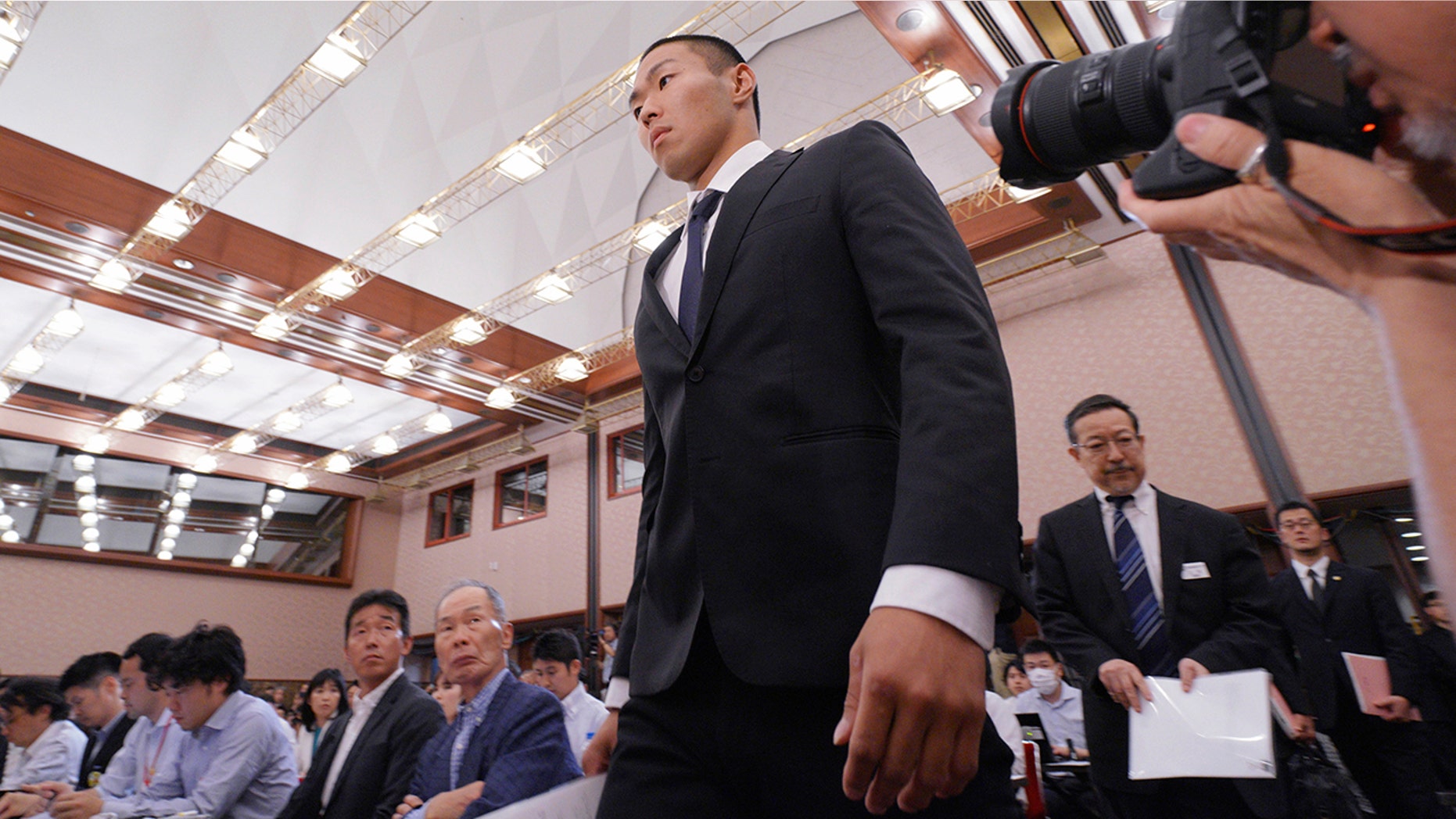 Nihon University's American football player Taisuke Miyagawa arrives for a news conference.