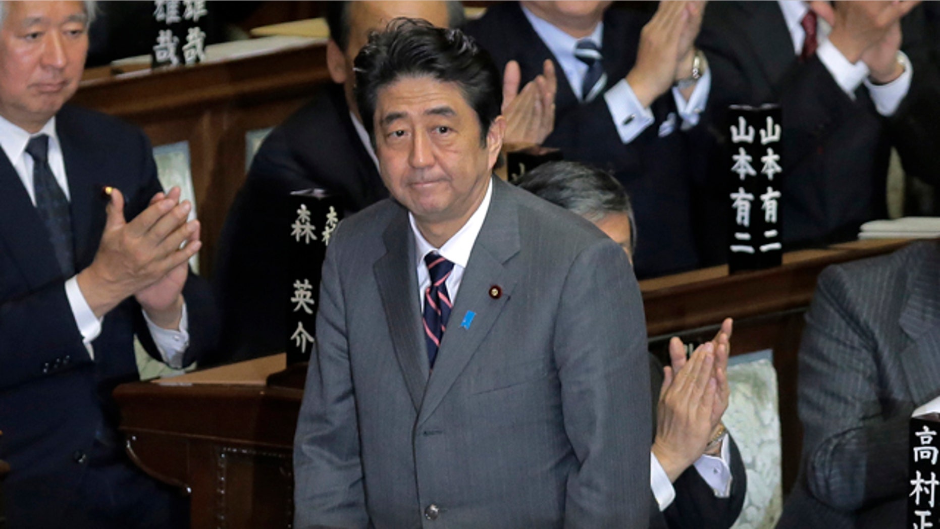 Dec. 26, 2012: Japan's Liberal Democratic Party leader Shinzo Abe acknowledges applause from lawmakers after being named Japan's new prime minister at the lower house of Parliament in Tokyo.
